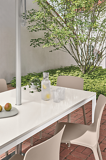 Outdoor setting with parsons 72-wide outdoor table in white with tiffany side chair in taupe.