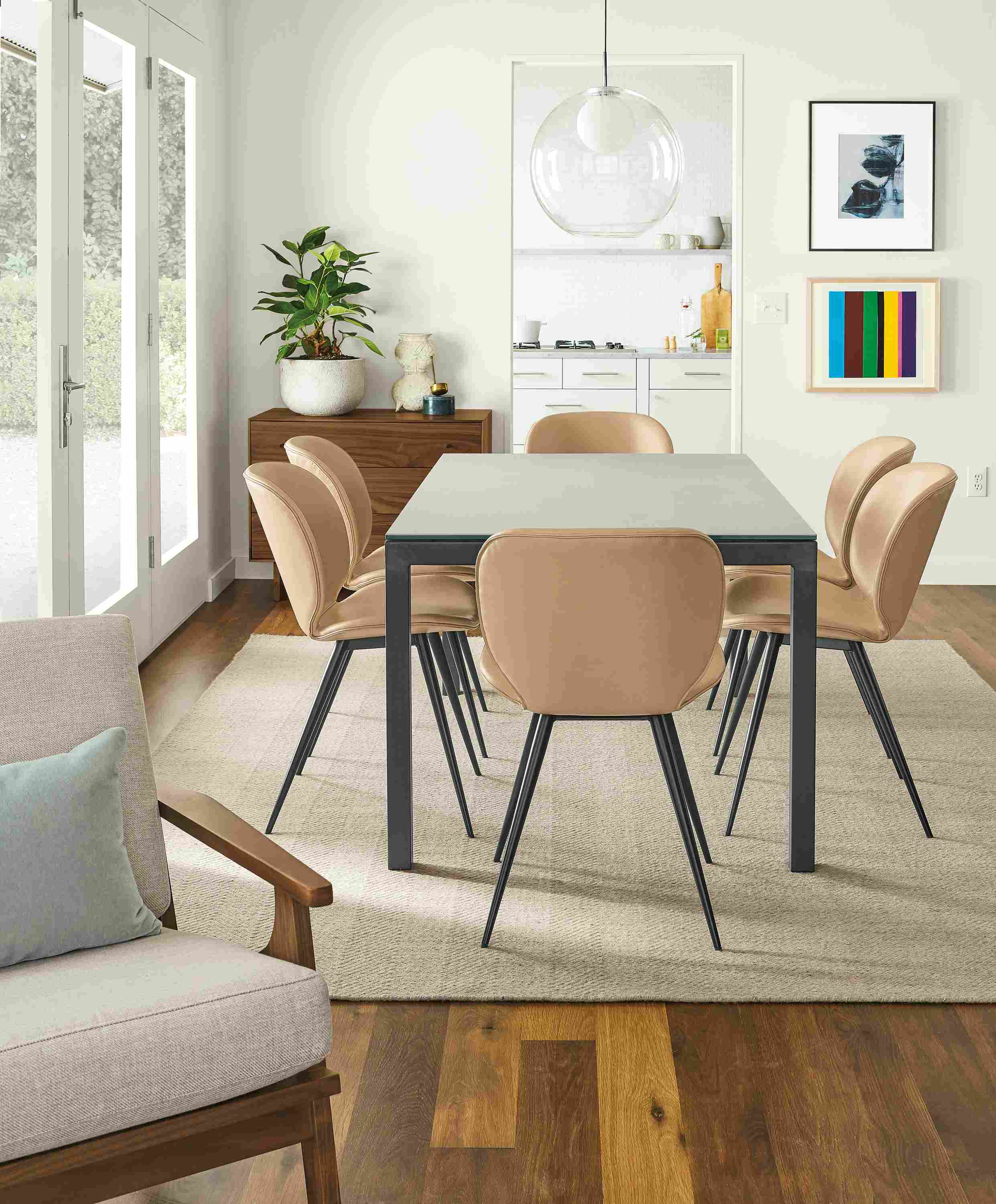 Detail of Parsons table with taupe ceramic top and natural steel base with Gwen Nola leather side chairs.
