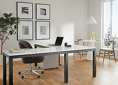 Office area with Parsons Adjustable height standing desk in graphite and light grey quartz top in seated position with Cora office chair.