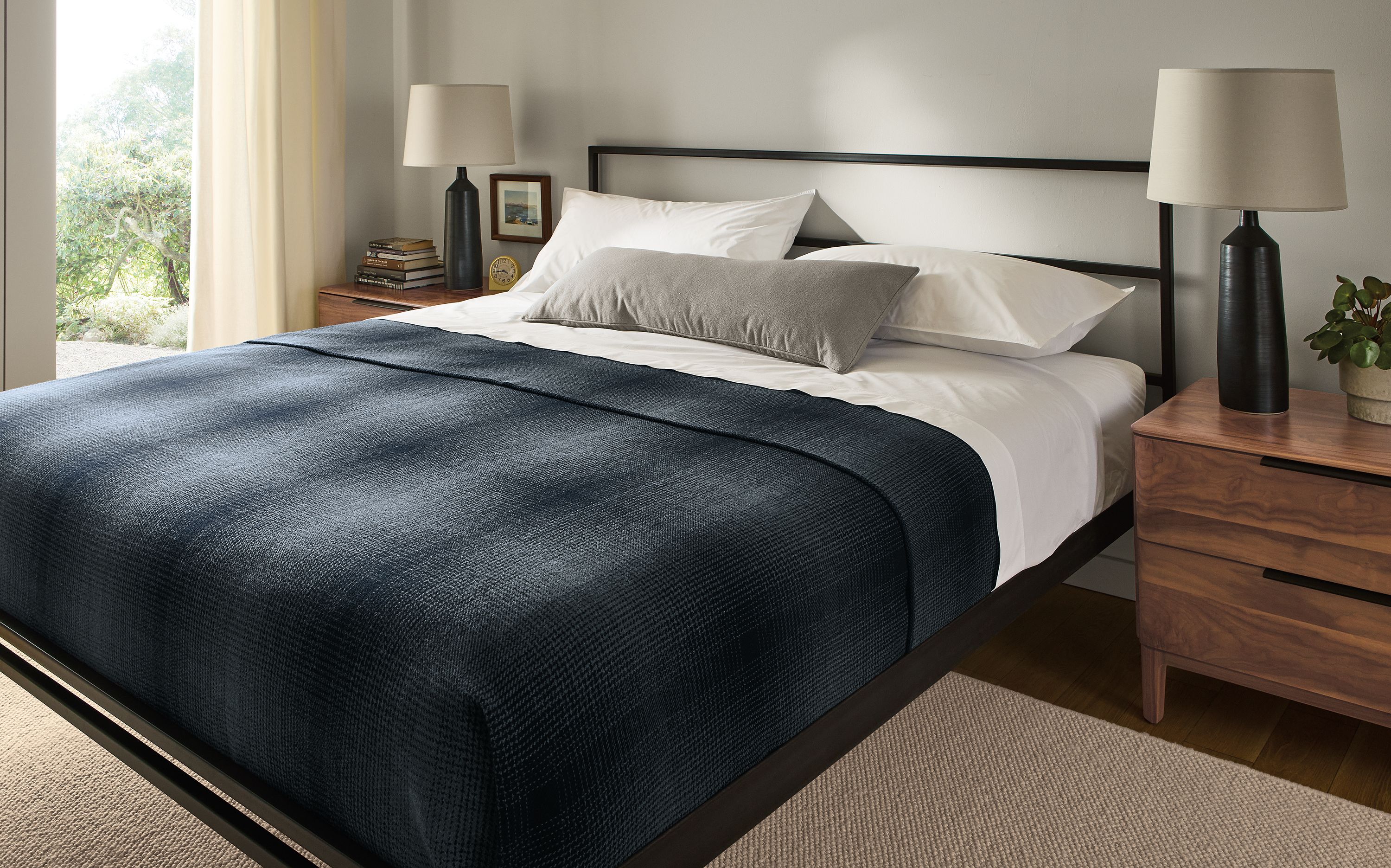 Bedroom with Parsons king bed in natural steel, 2 kingston 2-drawer nightstands in walnut and Flannery rug in oatmeal.