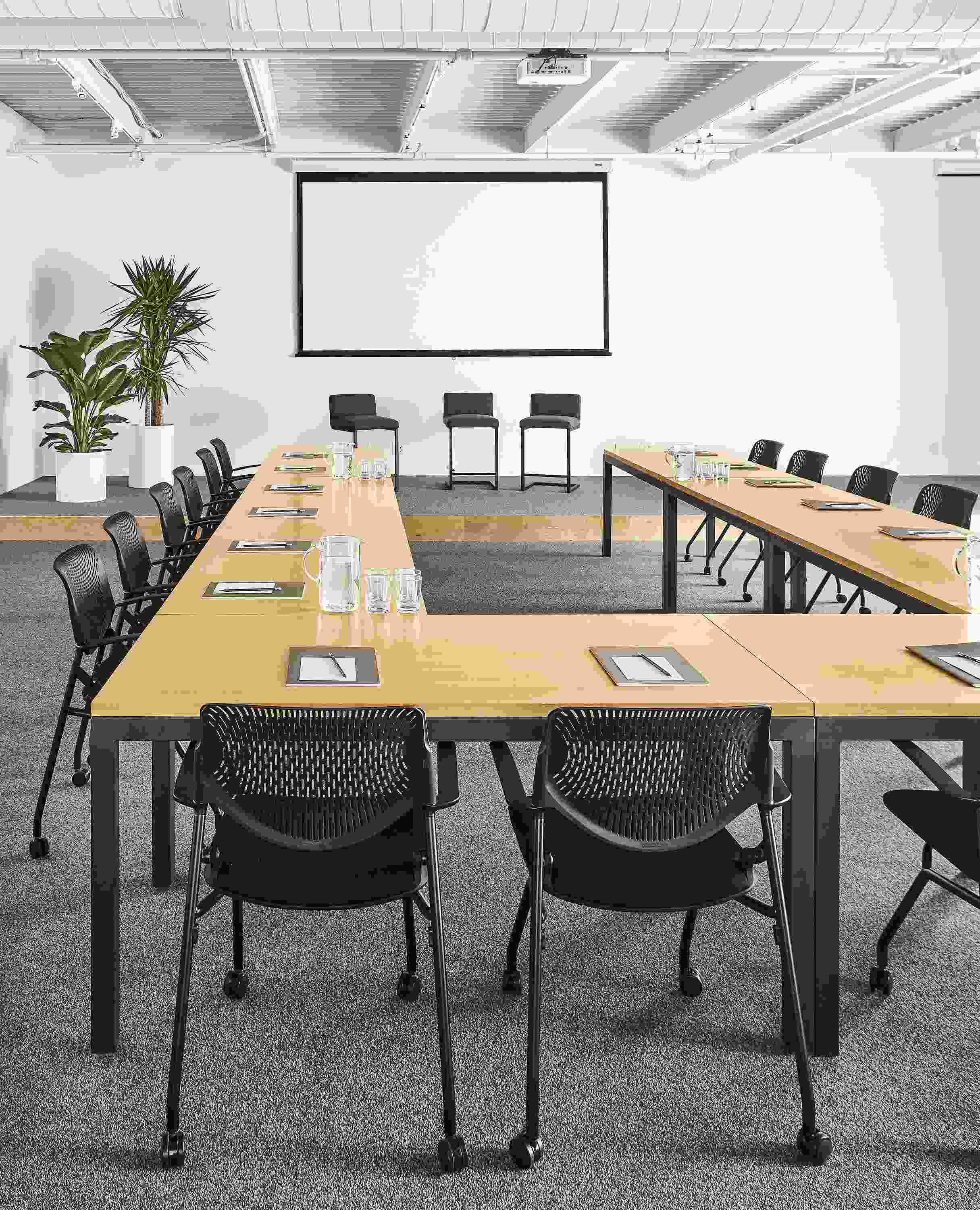 Detail of Parsons tables (8) in maple and graphite in conference room setting in U shape arrangement.
