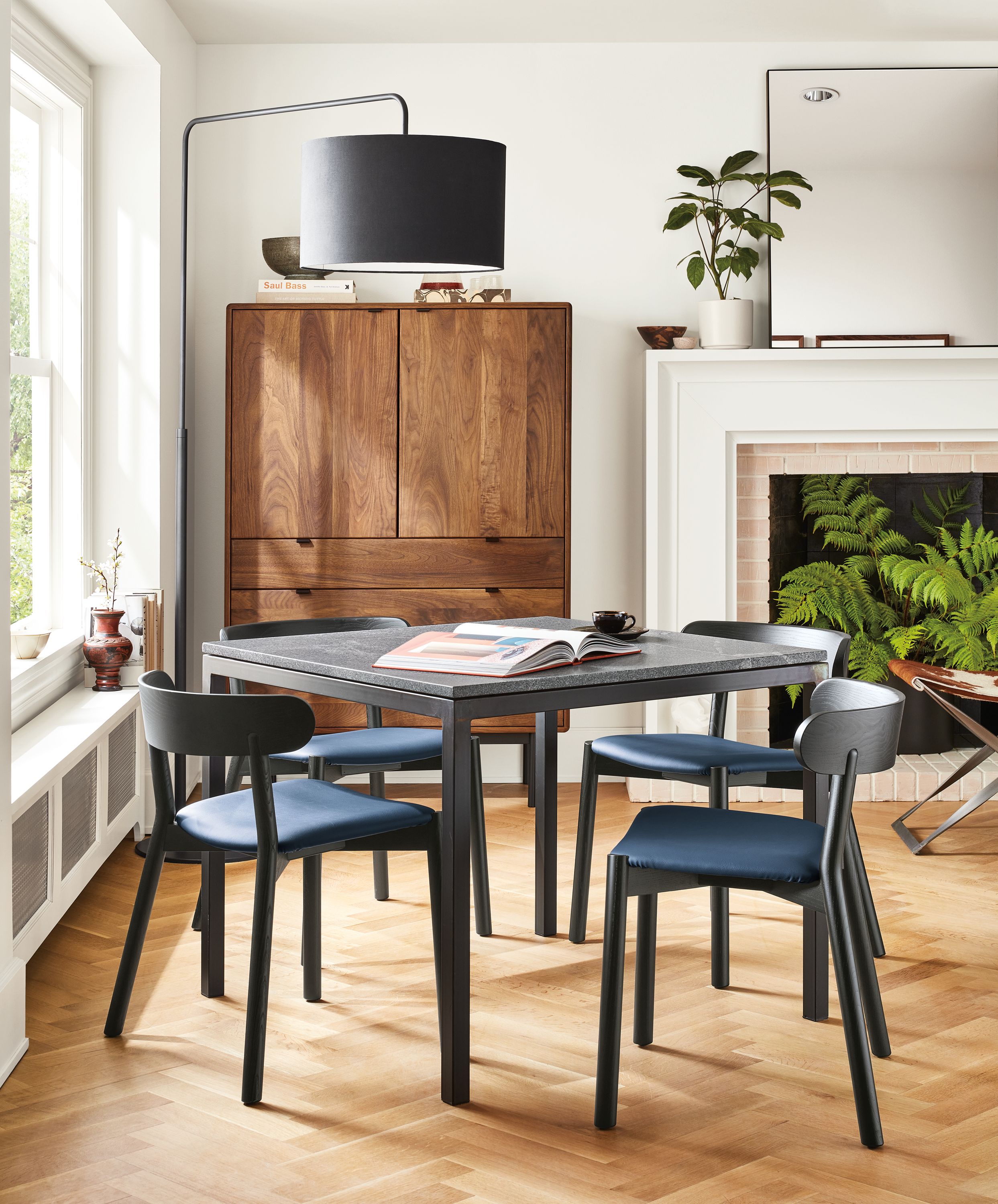 small dining area with parsons table with natural steel base and gray granite top