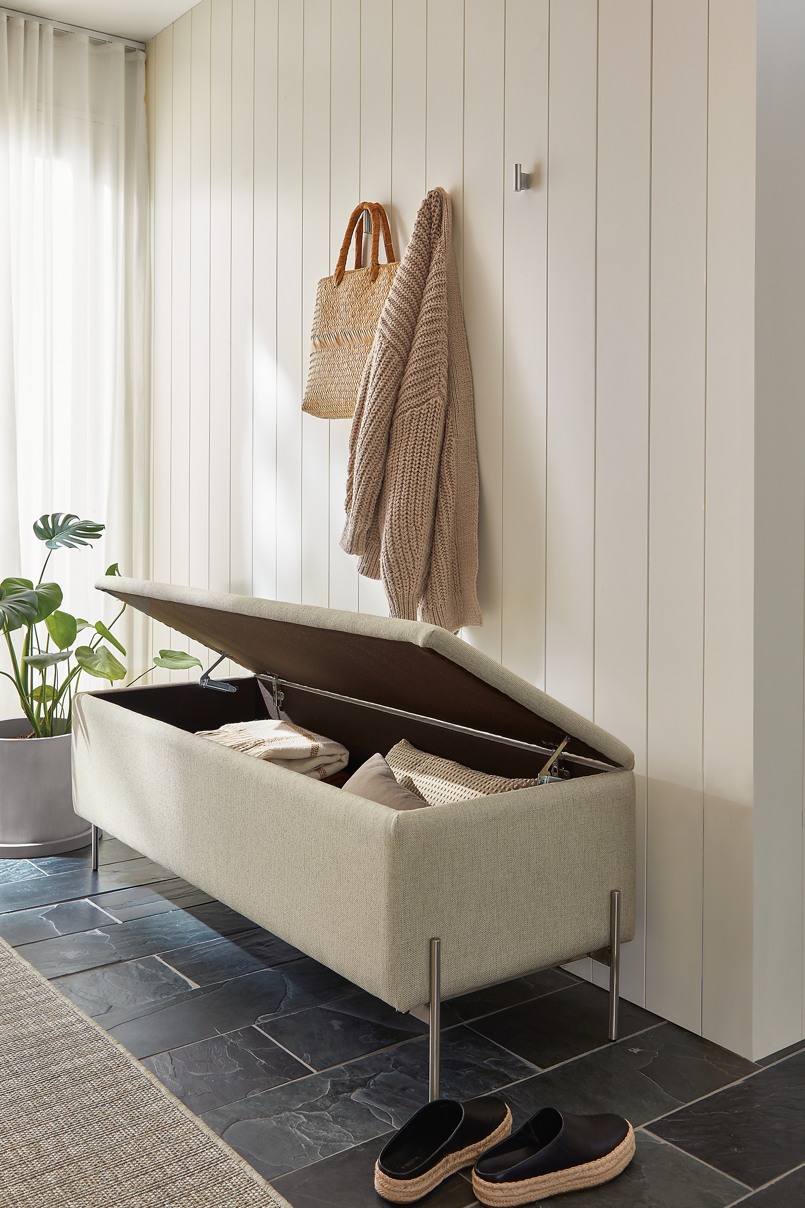 Entryway with paxton 54-wide storage bench in Sumner Linen fabric shown open.