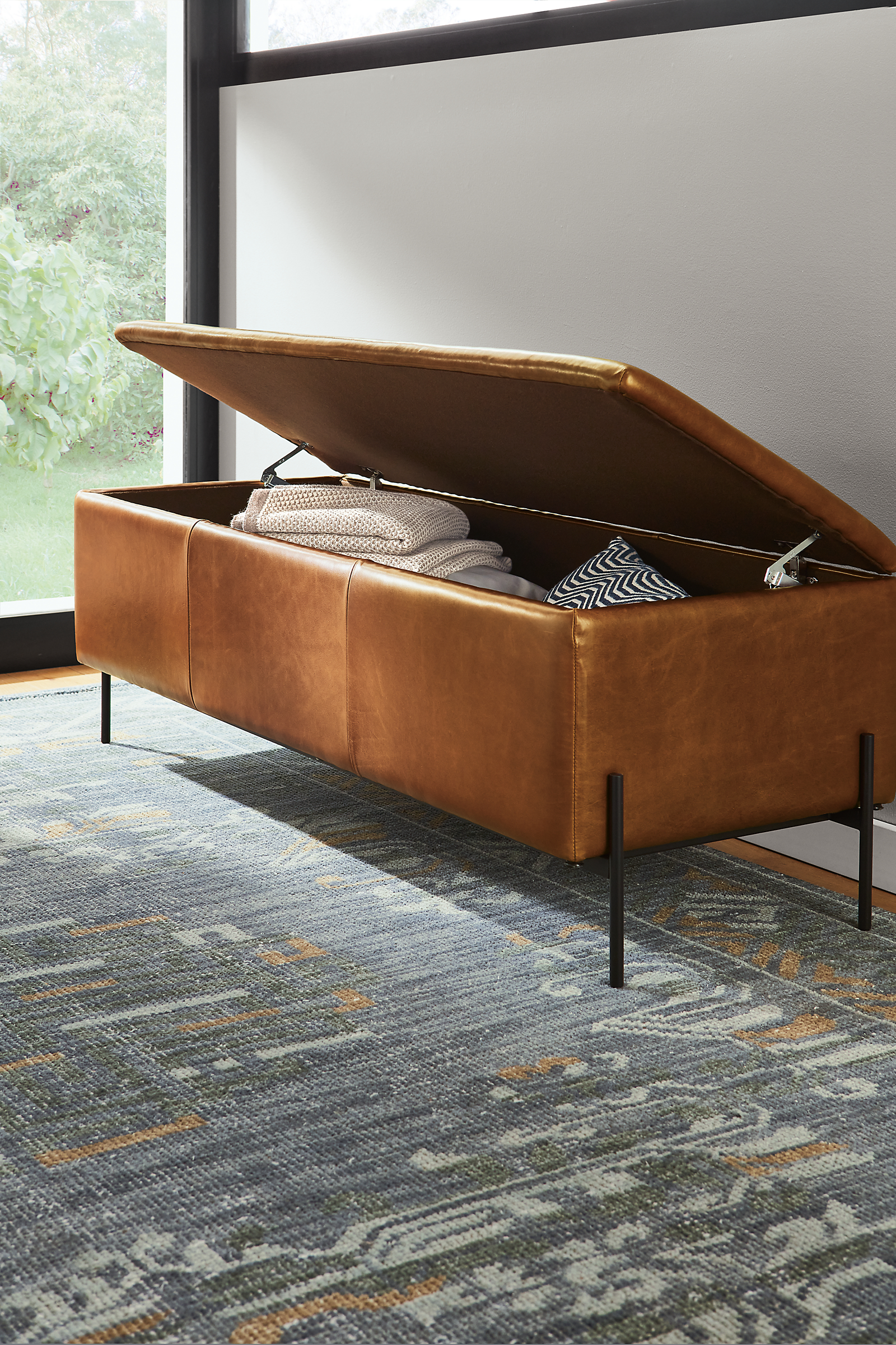 detail of paxton leather storage ottoman in entryway with top open.
