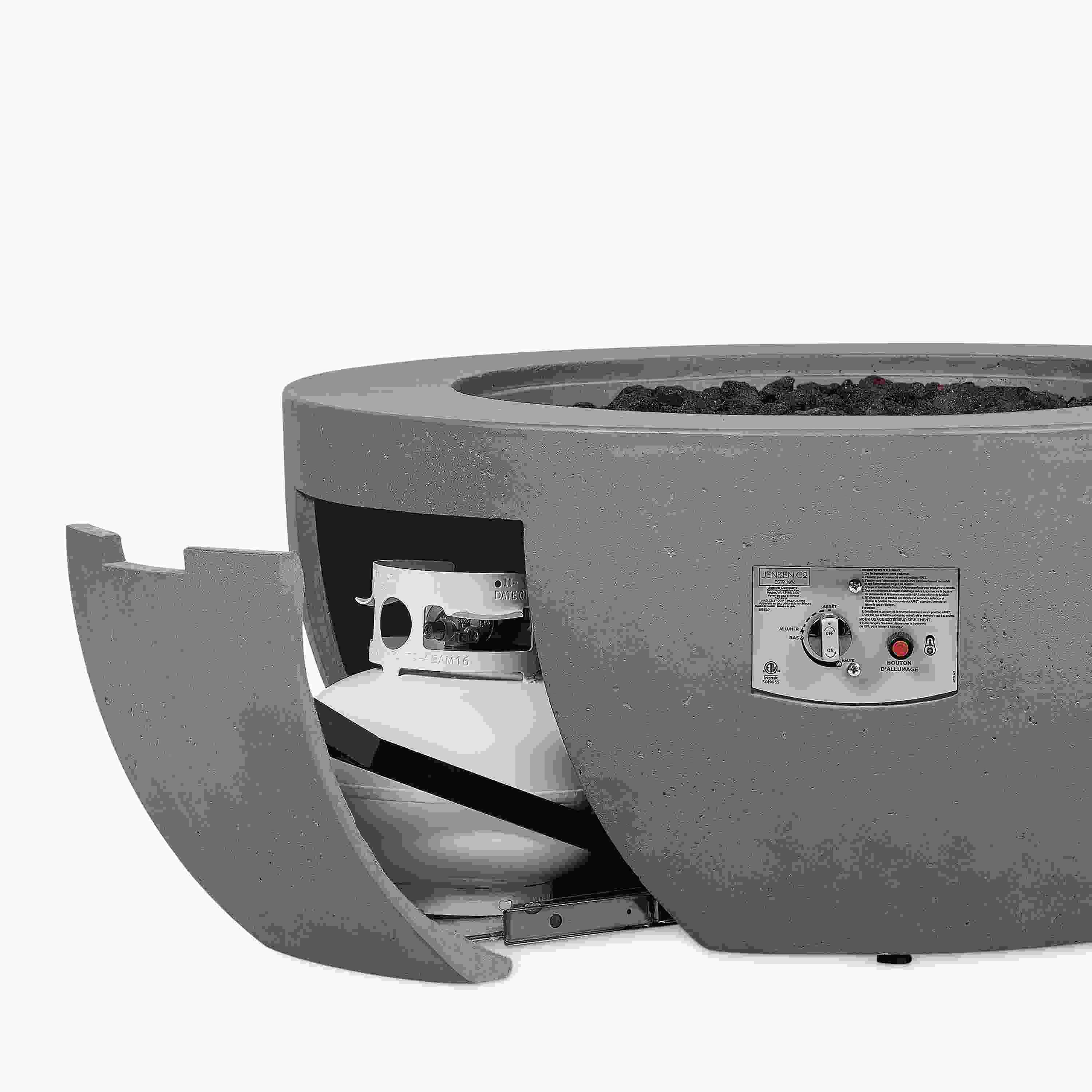 Pele 44-diameter outdoor propane fire table in grey concrete shown with tank access door open showing tank inside.