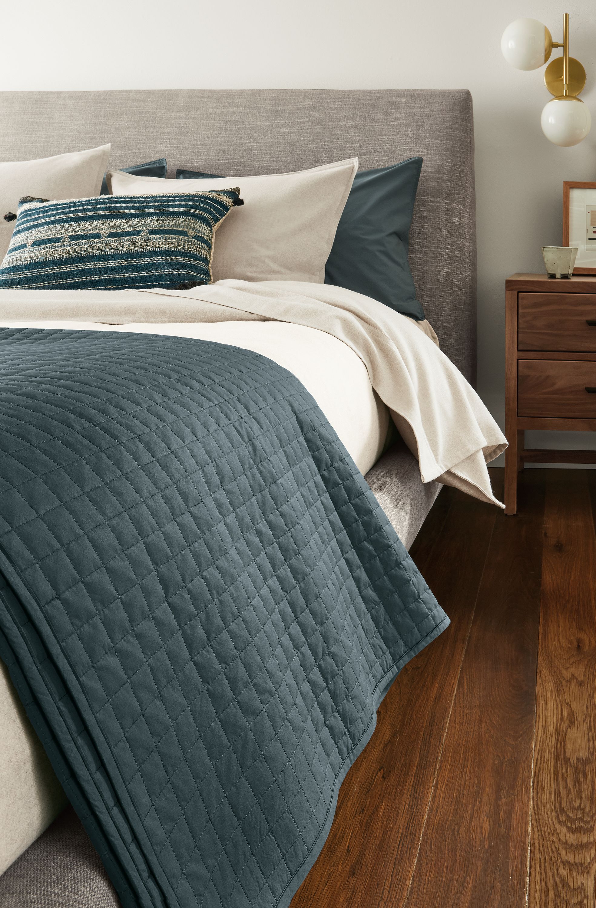 Bedroom with close-up of Signature Percale coverlet in dark slate on an Ella Queen Bed in Hawkins Cement.