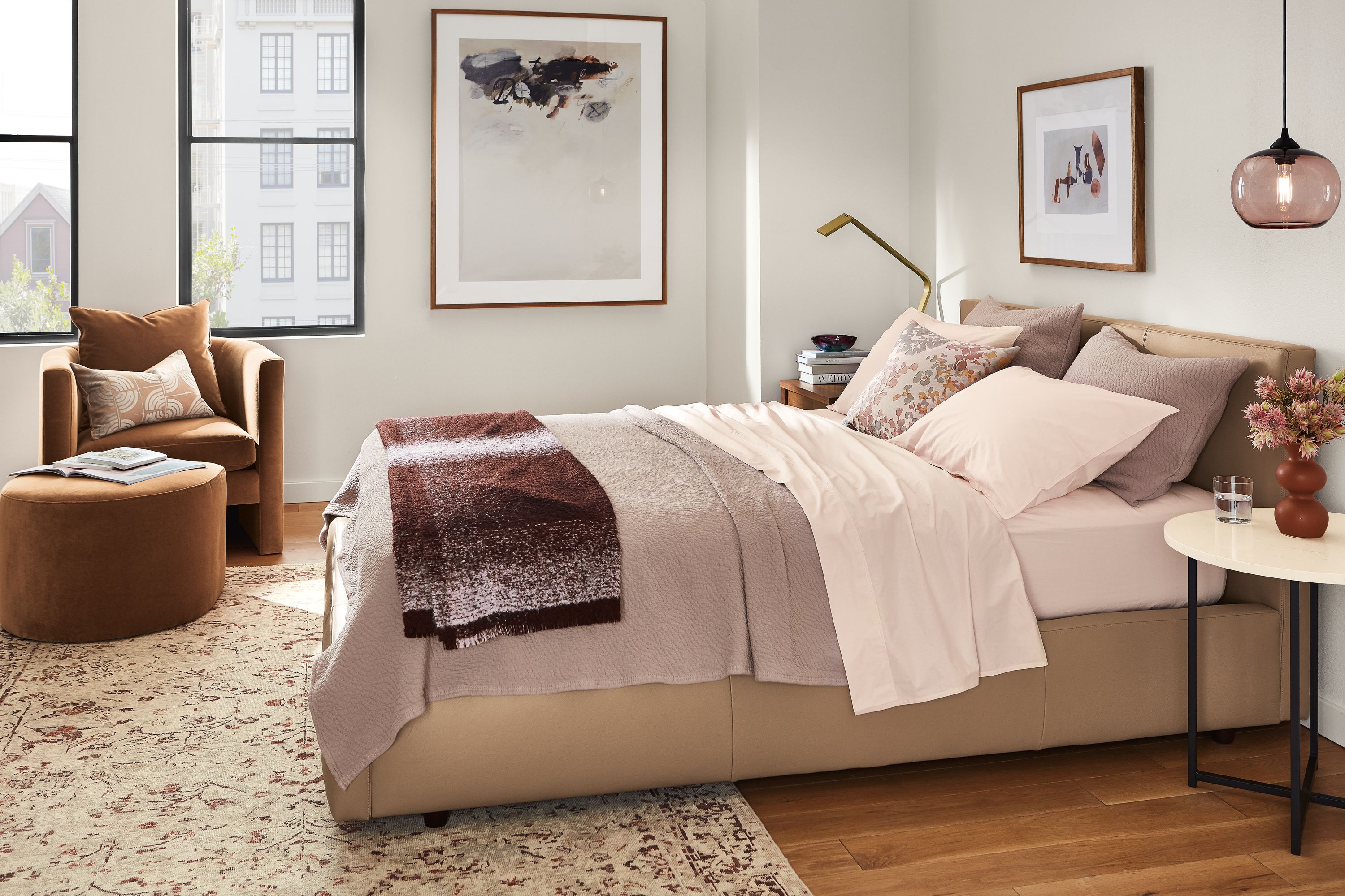 Bedroom setting with signature percale in blush and thea coverlet and sham on wyatt bed.