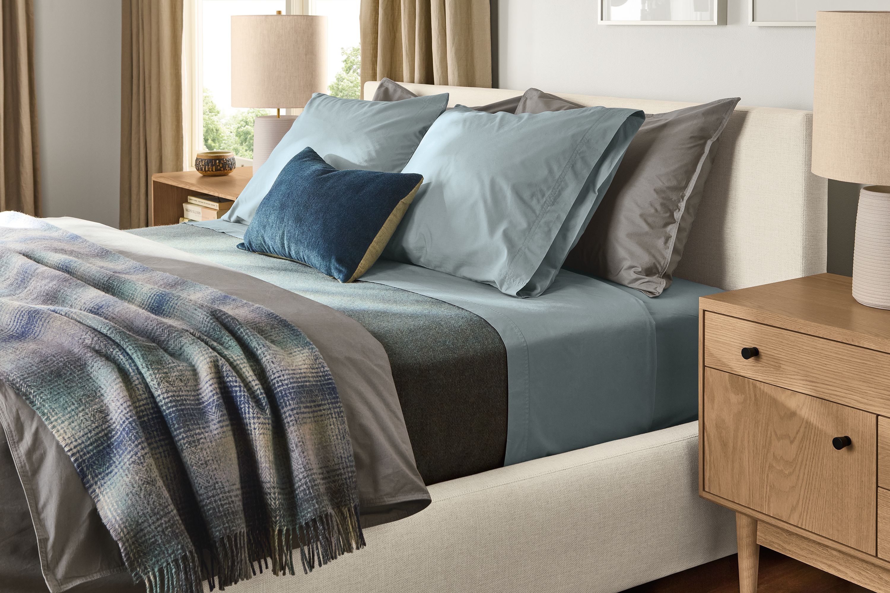 Wyatt queen bed with signature percale duvet cover and sham in charcoal and washable wool blanket in haze.