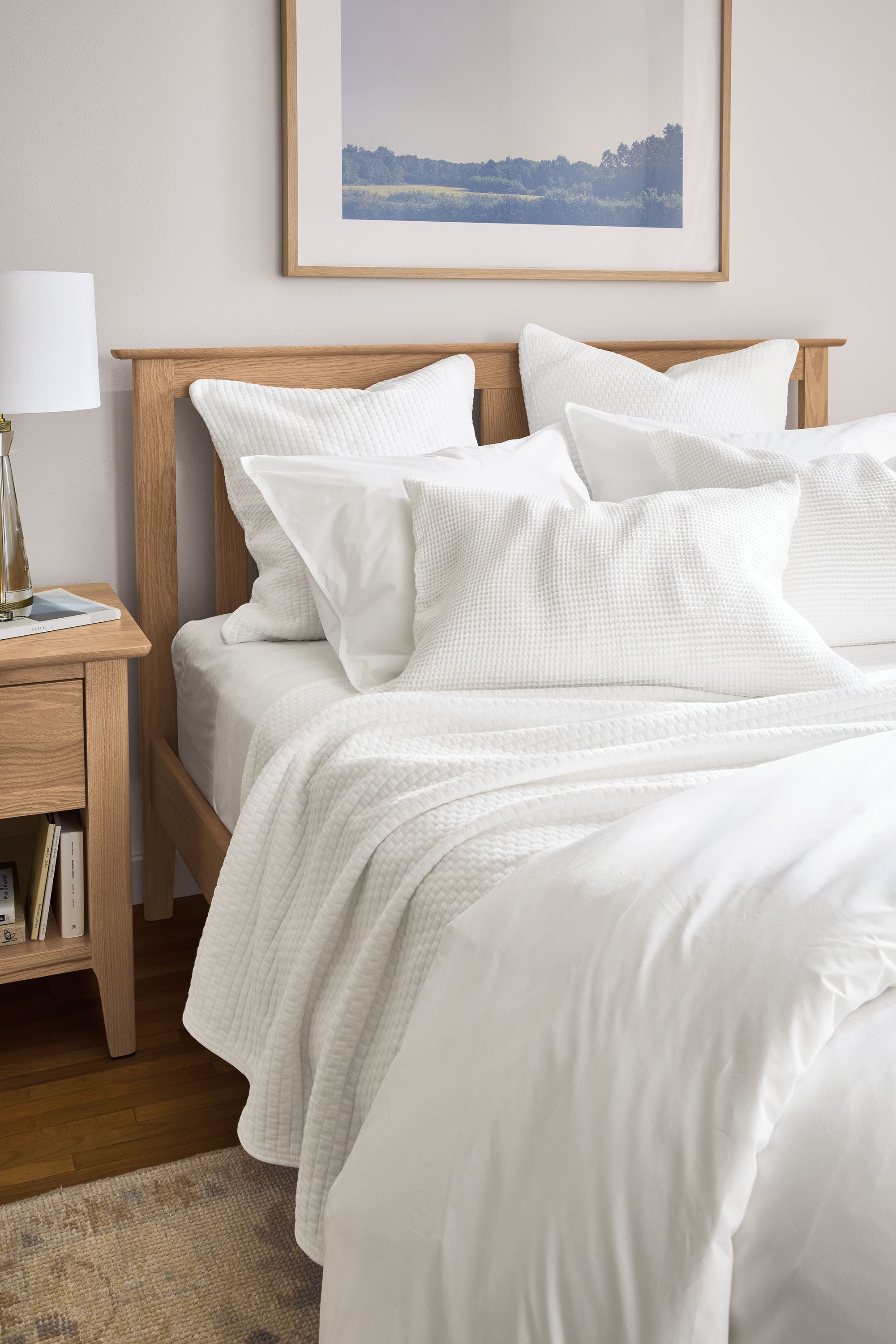 Bedroom with signature percale duvet cover, whitmore matelass coverlet and loren shams all in white on danbury bed in rye on red oak.