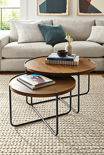 Living room setting with perimeter 32-round and 24-round end coffee tables in walnut. 
