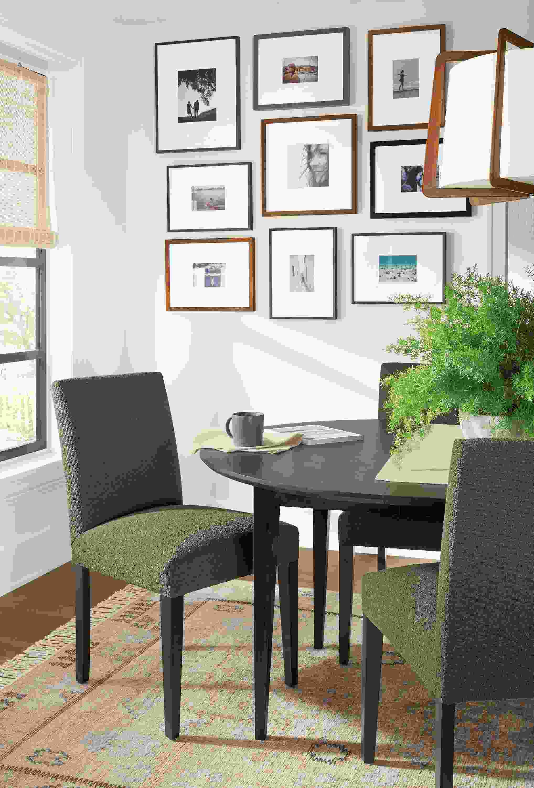 Detail of Peyton side chairs in Declan Olive fabric with charcoal legs in small dining room.