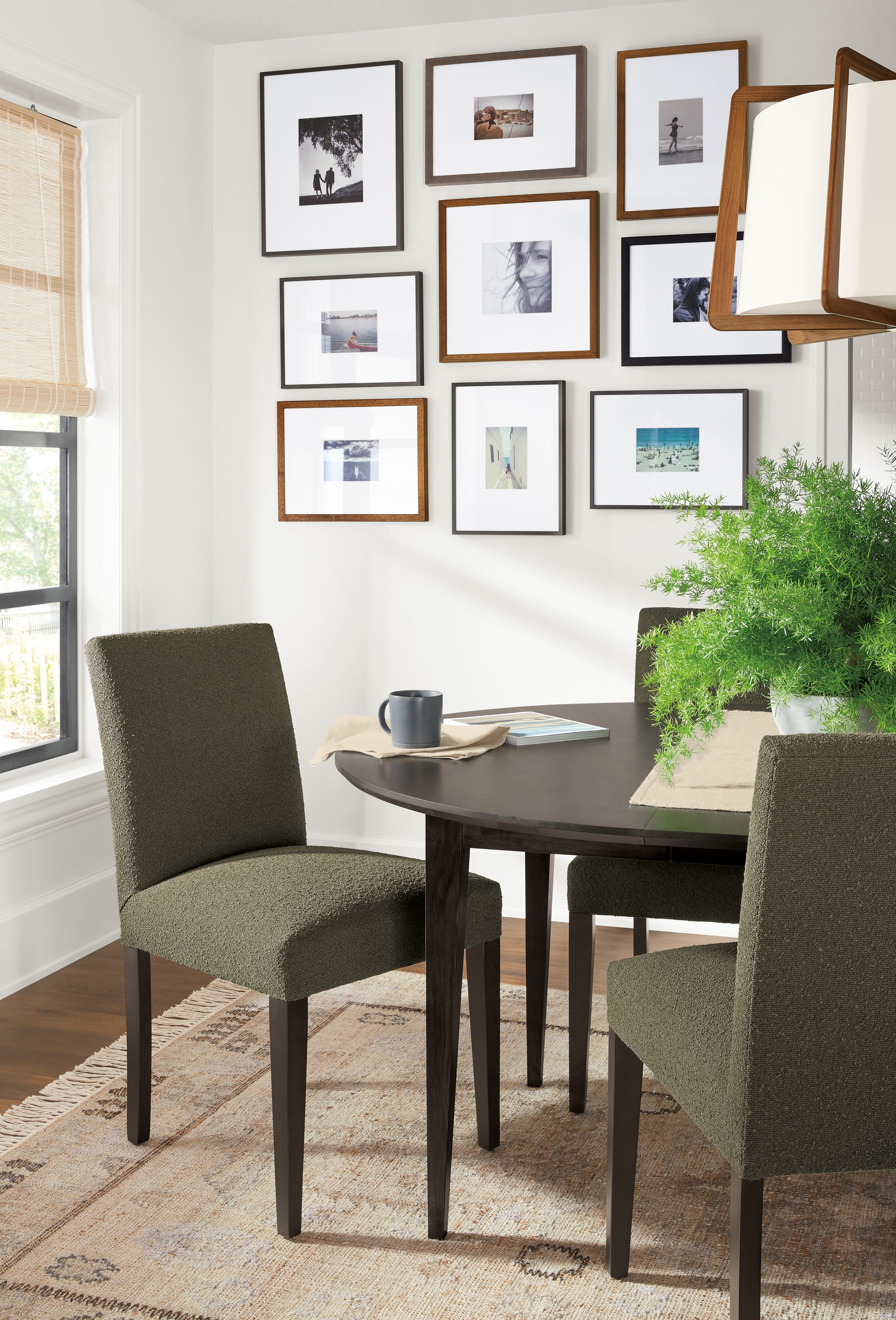 Detail of Peyton side chairs in Declan Olive fabric with charcoal legs in small dining room.