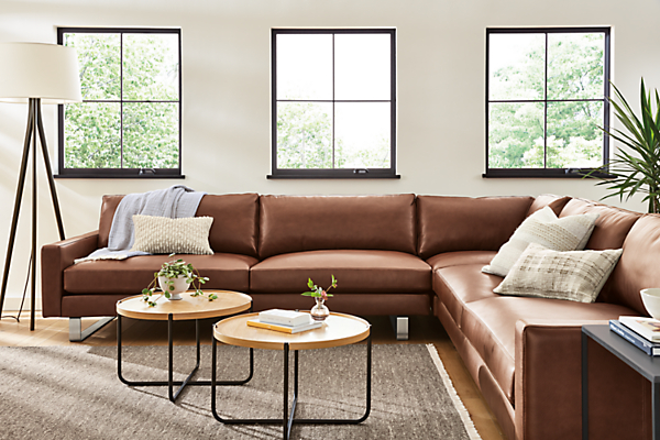 living room with pierson sectional in lecco cognac leather and two perimeter coffee tables