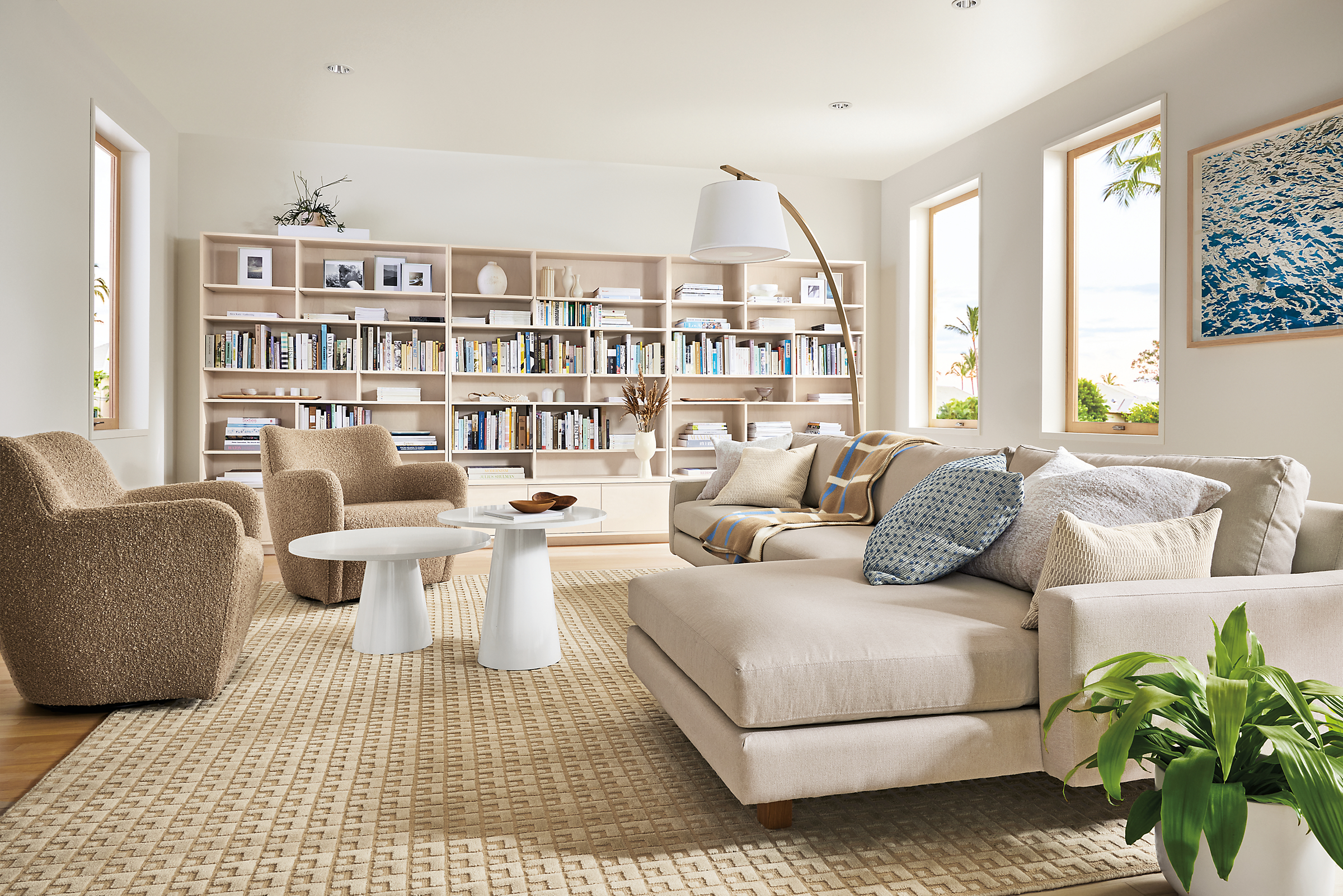 living room with pierson sofa with chaise, two lily chairs, keaton bookcases.