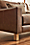 Detail view of Pierson leather sofa with white oak wood foot.