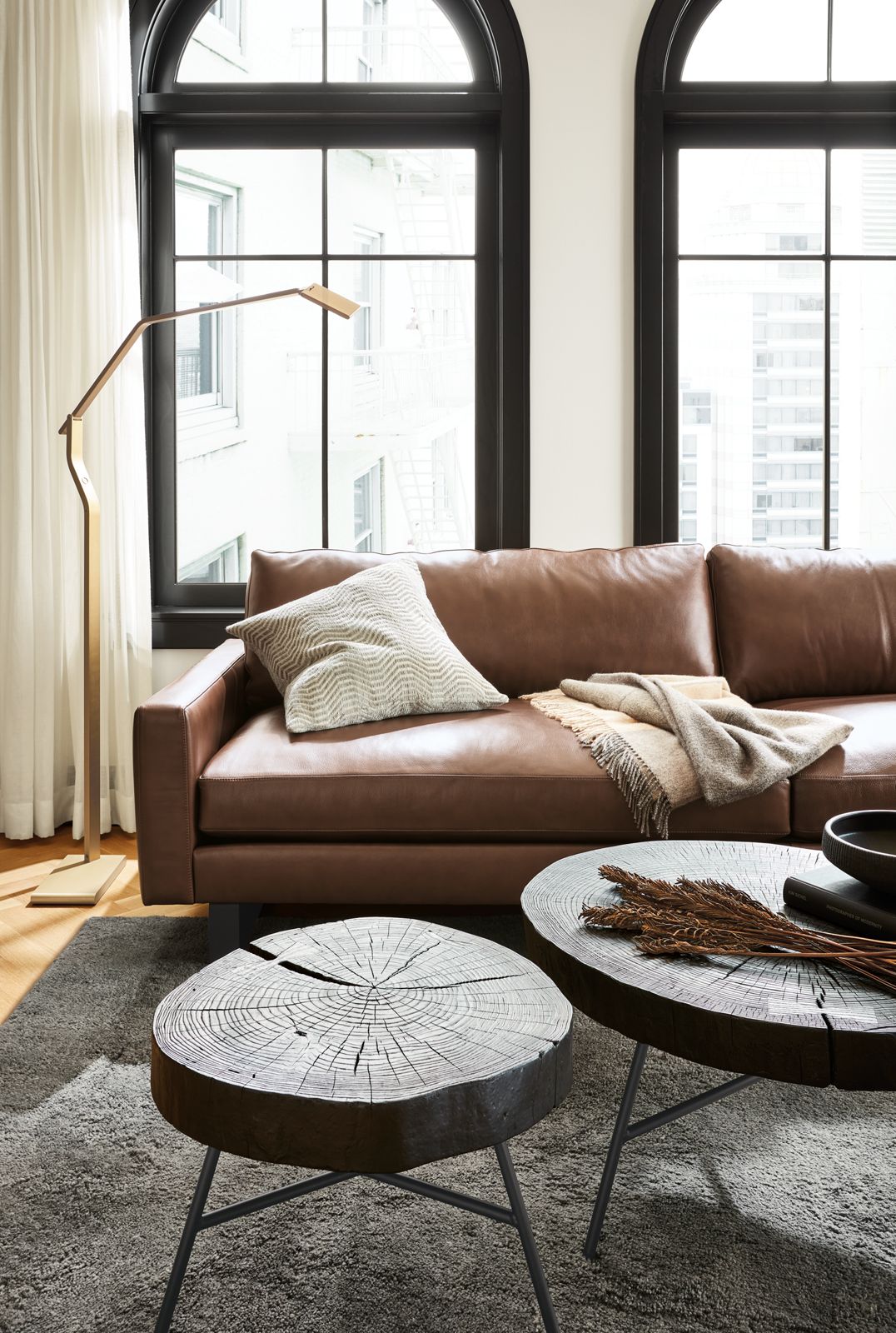 Living room with Prospect coffee tables and pierson leather sofa with metal base.