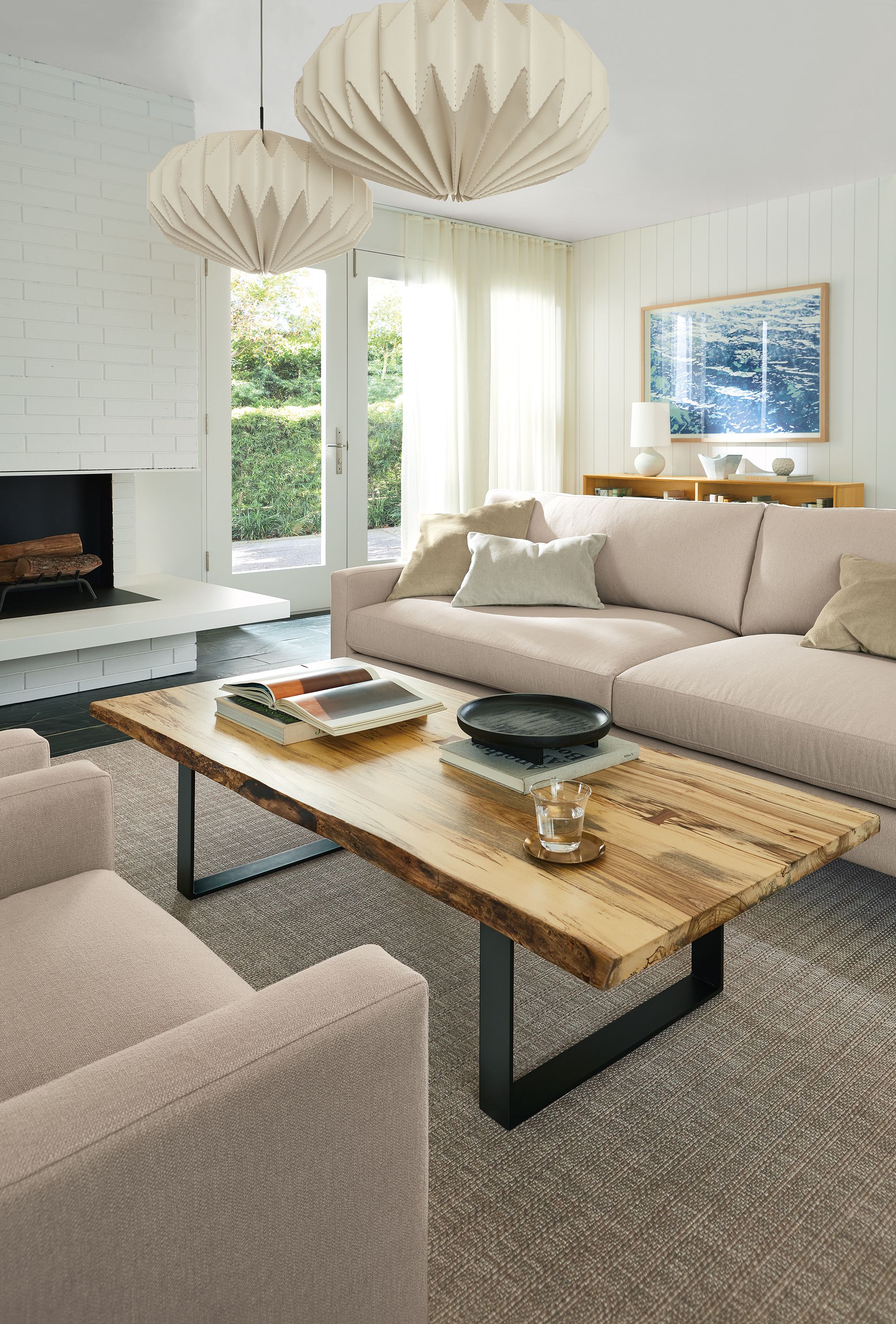 Living room with Pierson sofa in Hines oatmeal fabric, chilton coffee table in spalted sugarberry and orikata pendants.