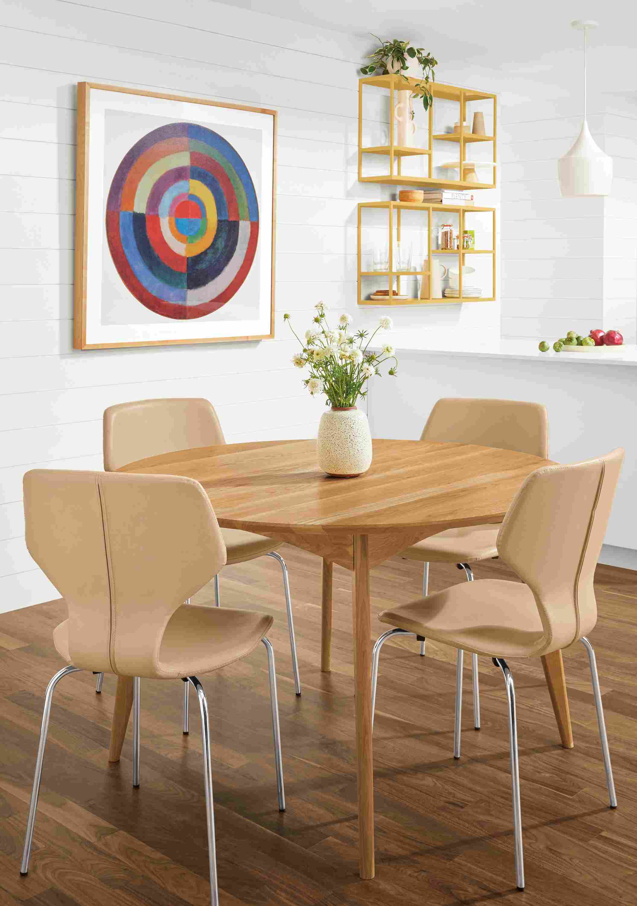 Detail of 4 Pike side chairs in Buff Nola leather at round table.