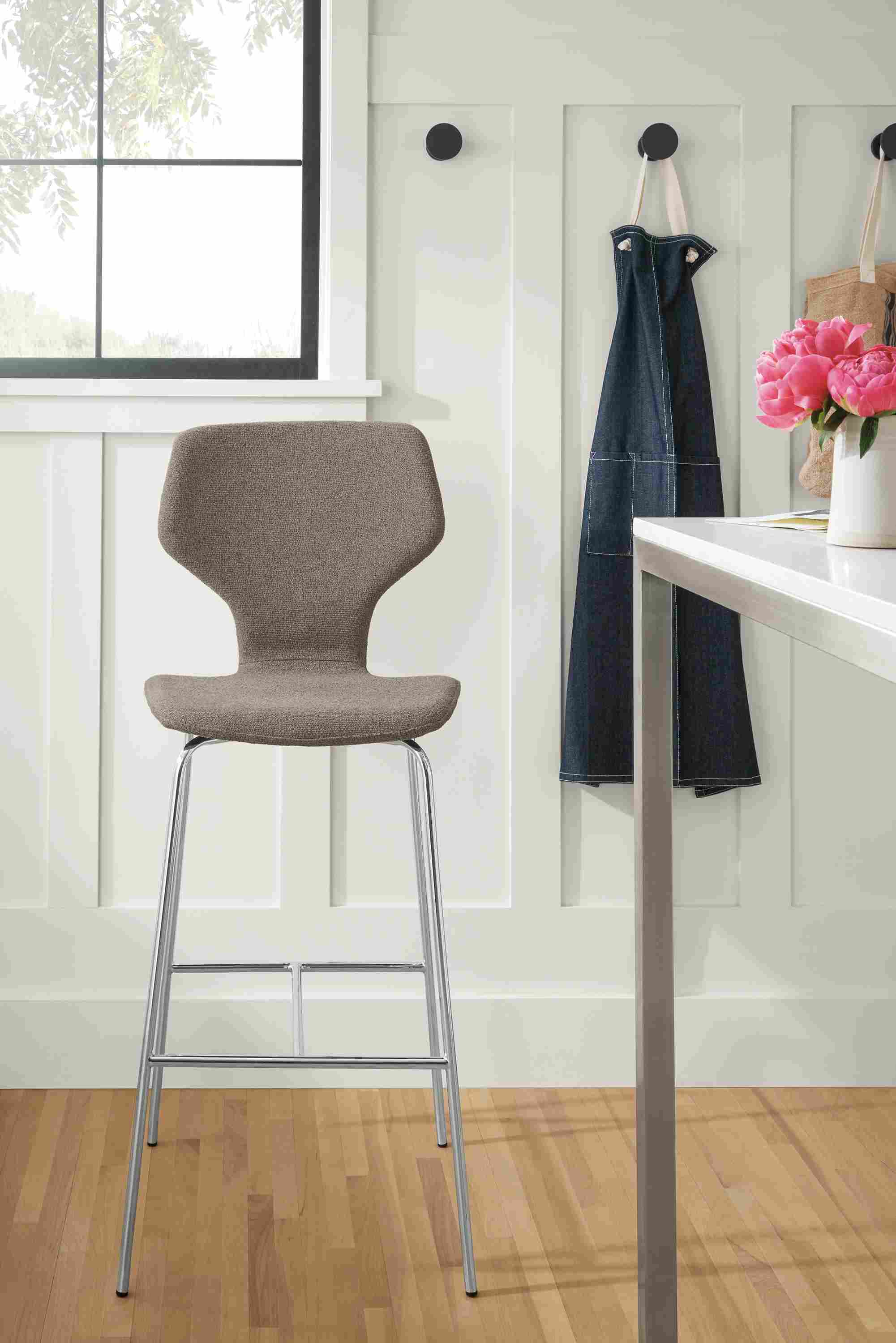 Detail of Pike bar stools in Radford Taupe fabric with metal base.