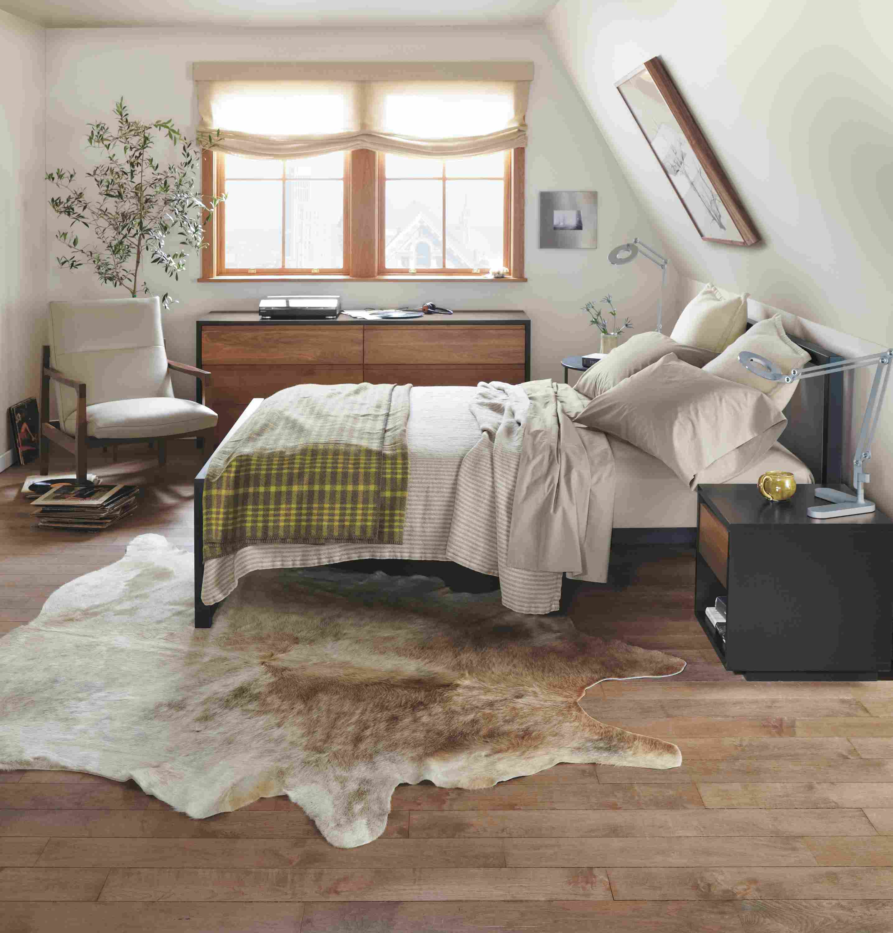 Detail of Piper queen bed with natural steel frame and putty fabric panels.