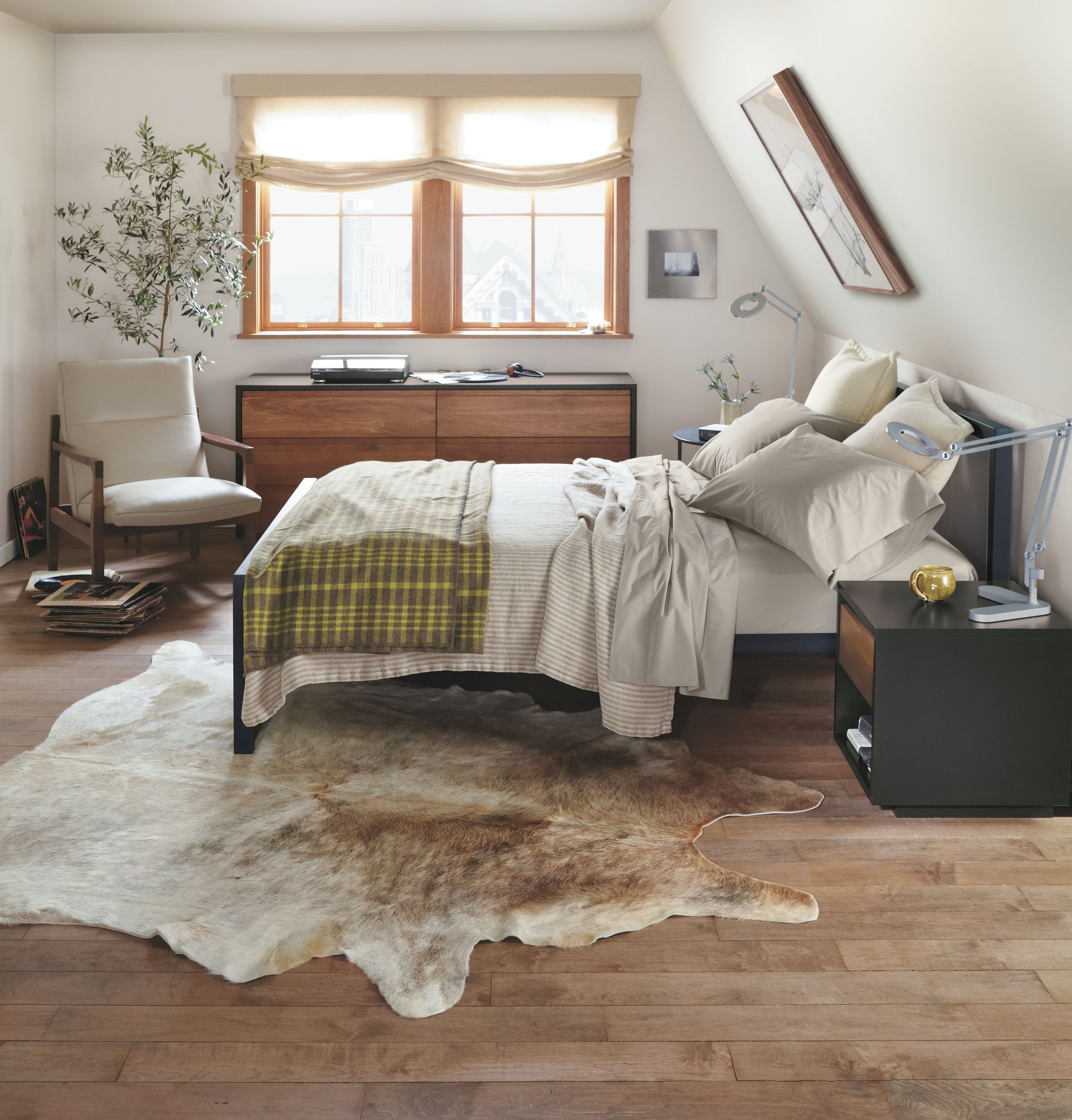 Detail of Piper queen bed with natural steel frame and putty fabric panels.