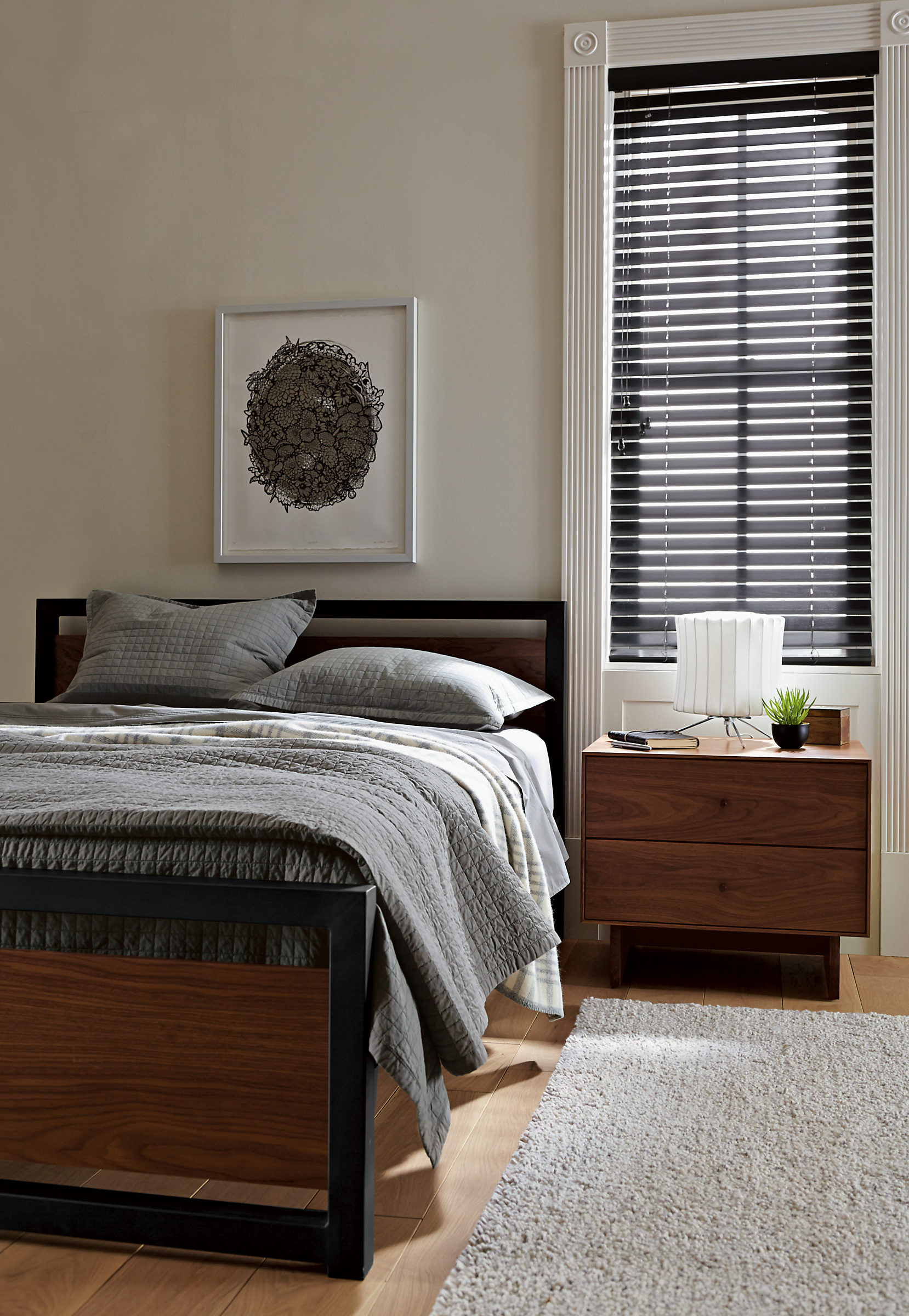 Bedroom setting with Piper bed with wood panels in walnut with hudson nightstand.