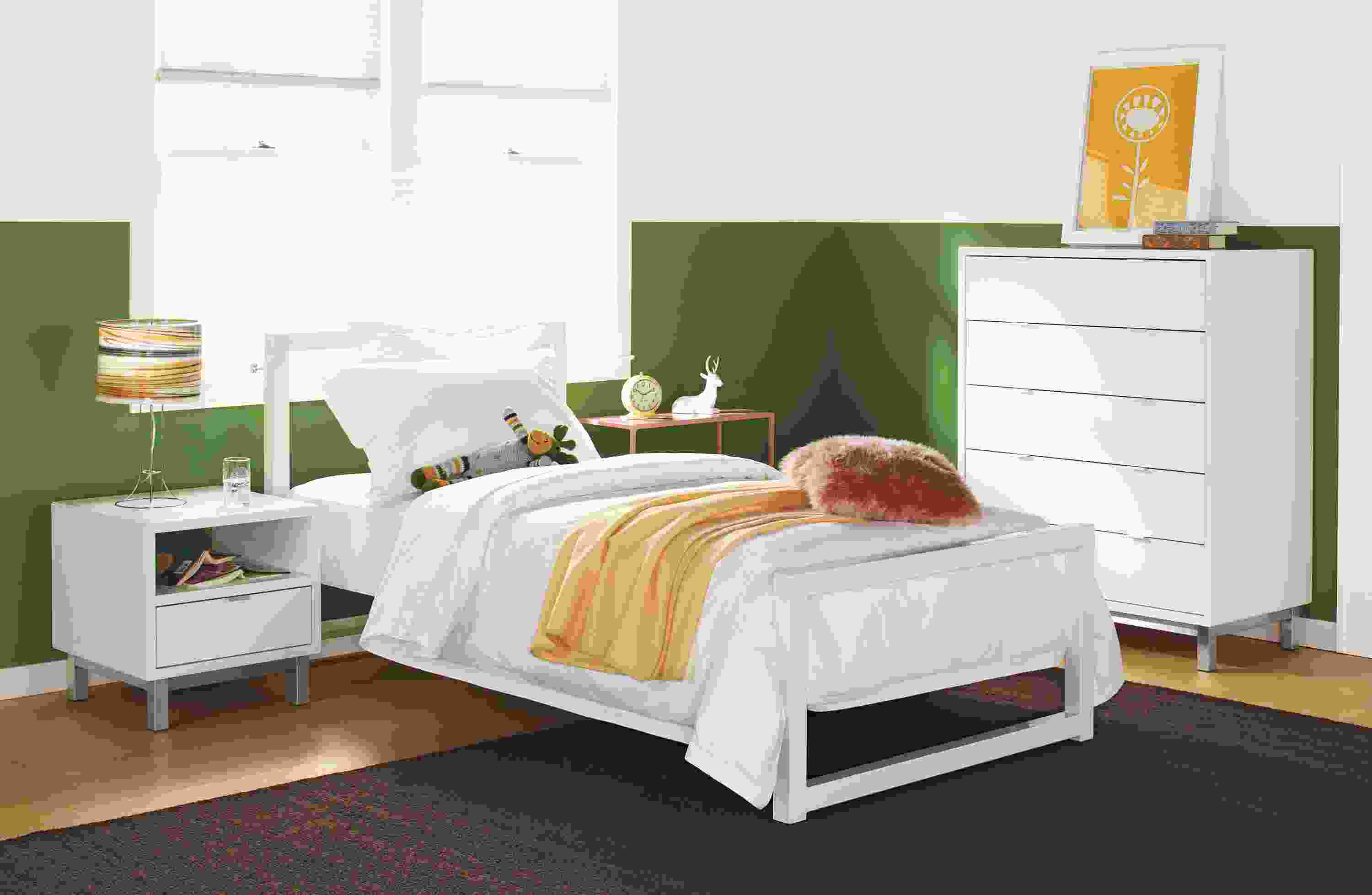Detail of Piper twin bed in white powder coated steel with white sheets.