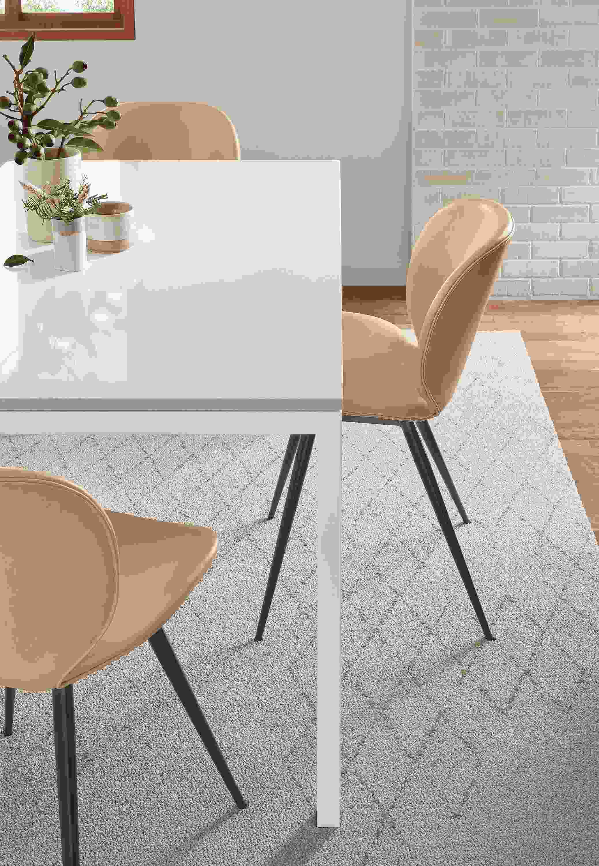 Dining room with Piran rug in beige with Parsons dining table.