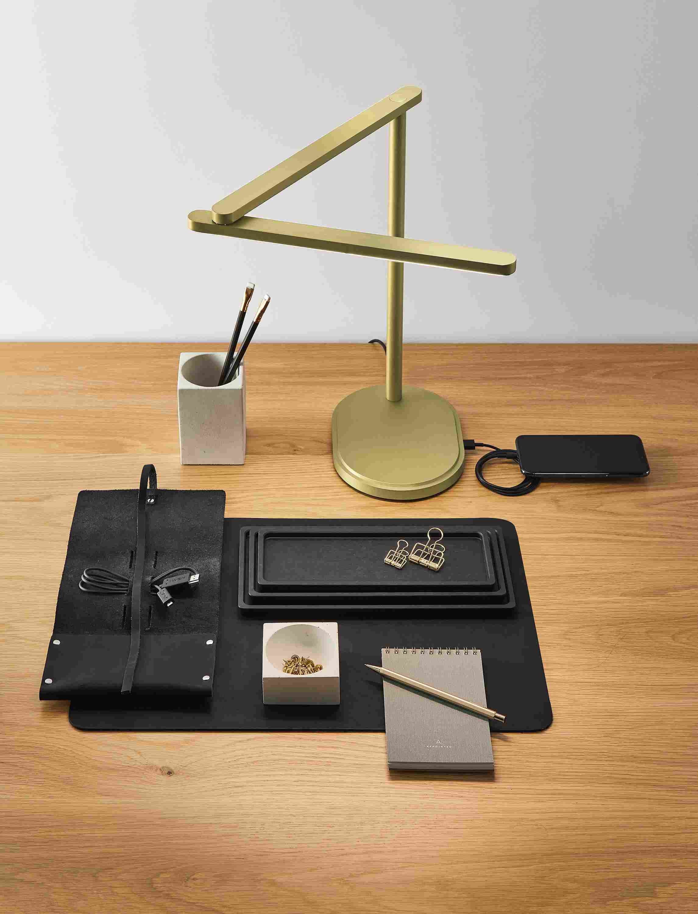 Desk with Pivot task lamp in brushed gold powdercoat and Saco pencil cup in white.