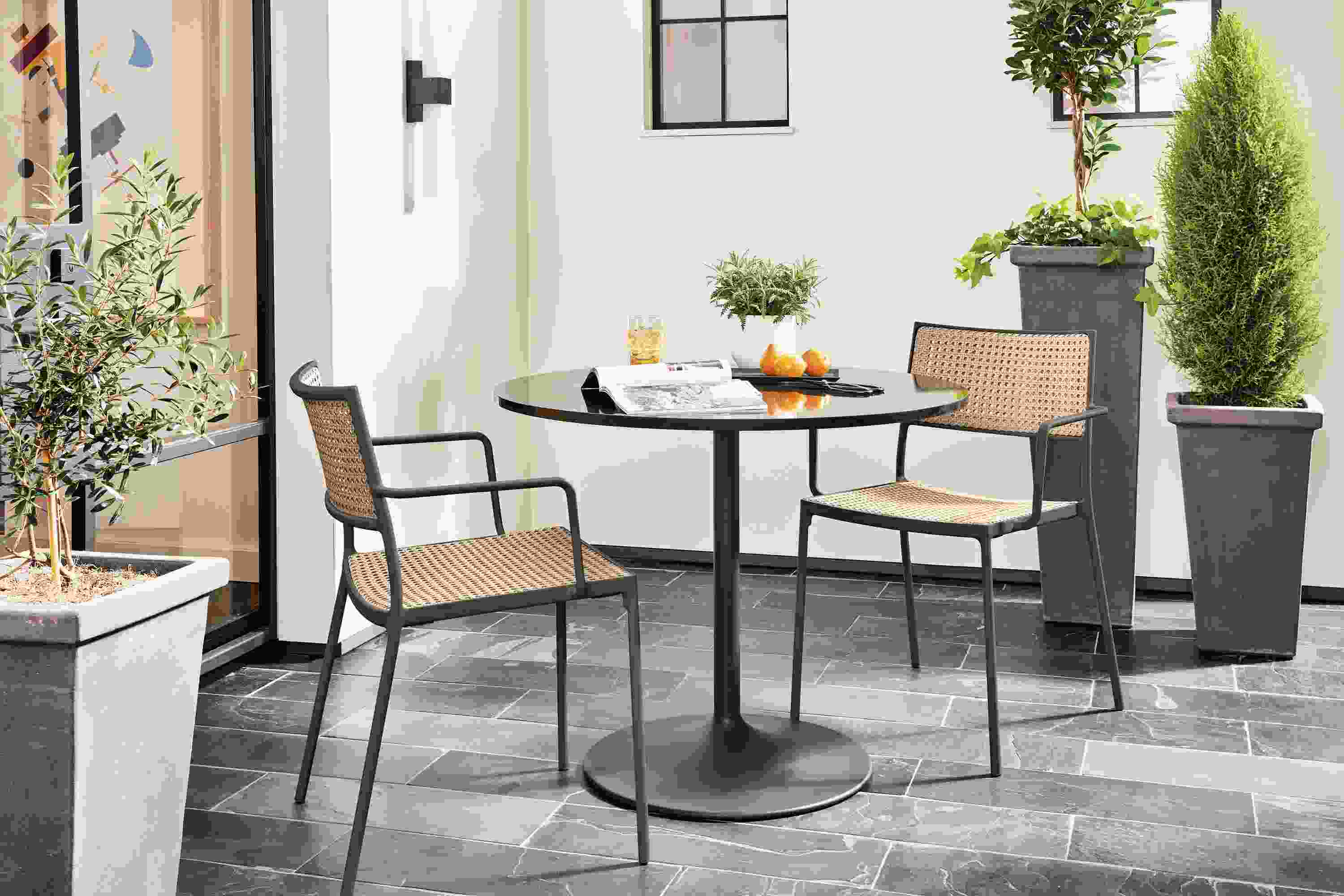Outdoor setting with Plat chair in natural with Aria outdoor table.