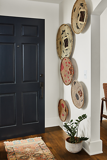Entryway setting with wall of Plateau baskets.