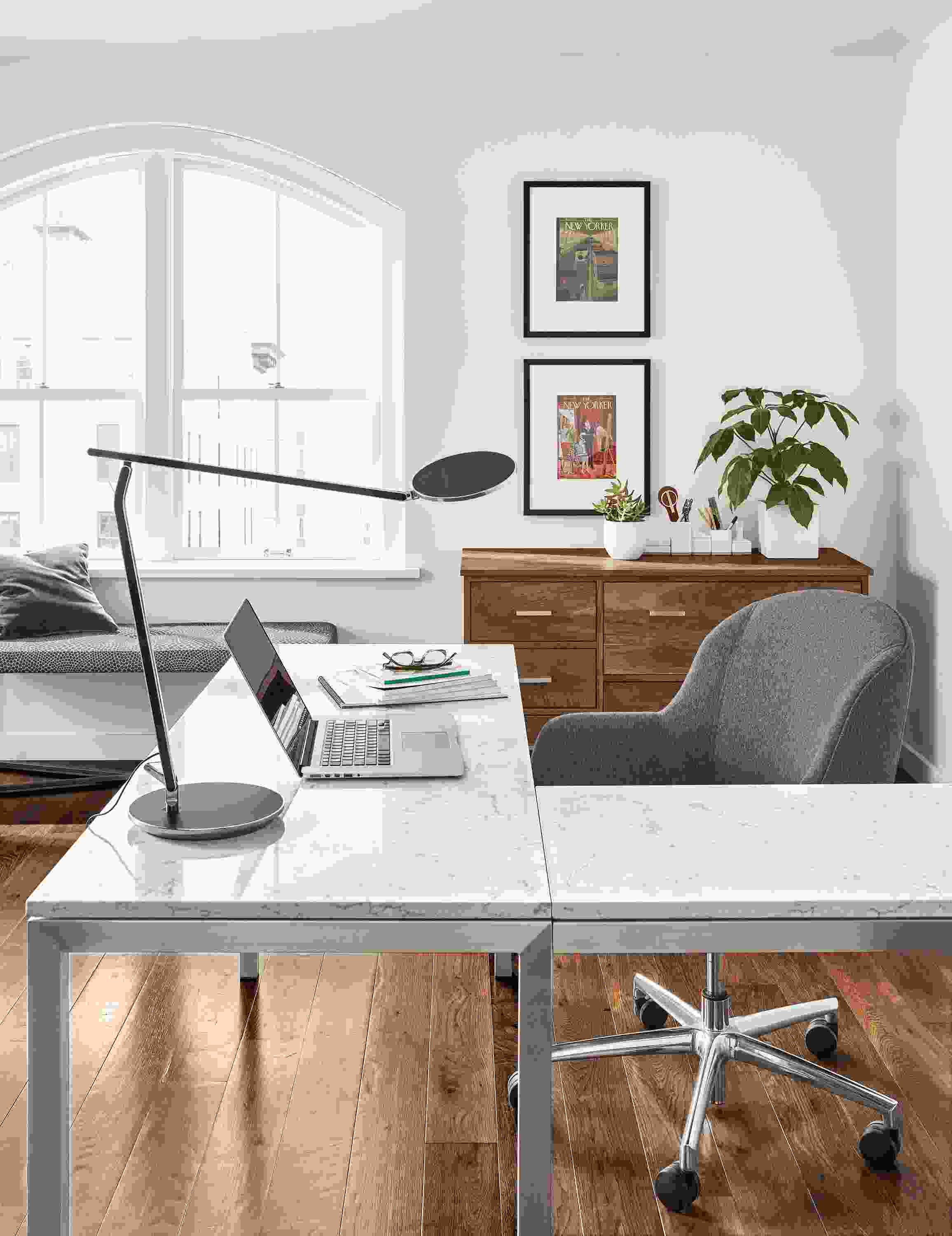 Detail of Parsons stainless steel L-shaped desk with stainless steel base and marbled white top.