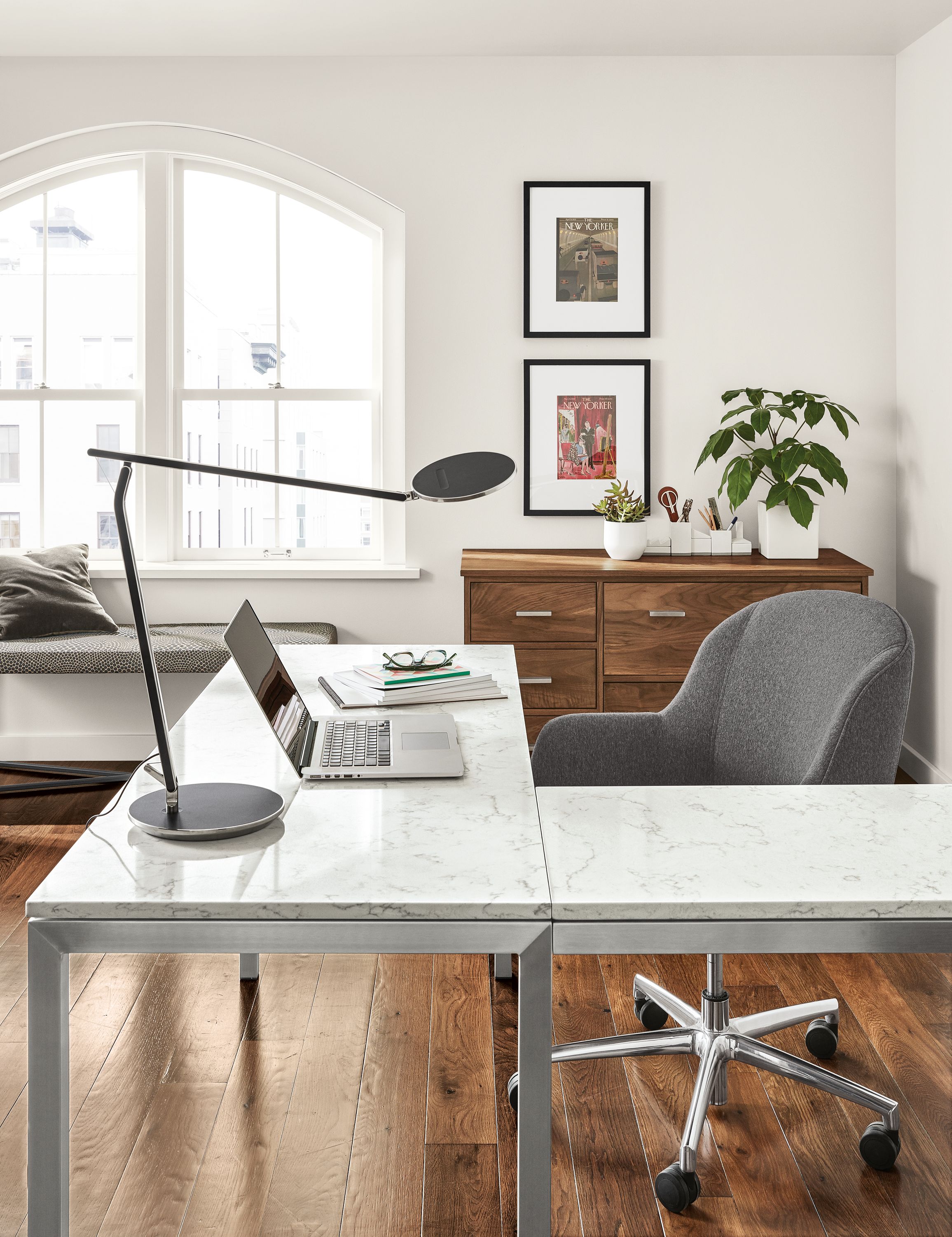 Detail of Parsons stainless steel L-shaped desk with stainless steel base and marbled white top.