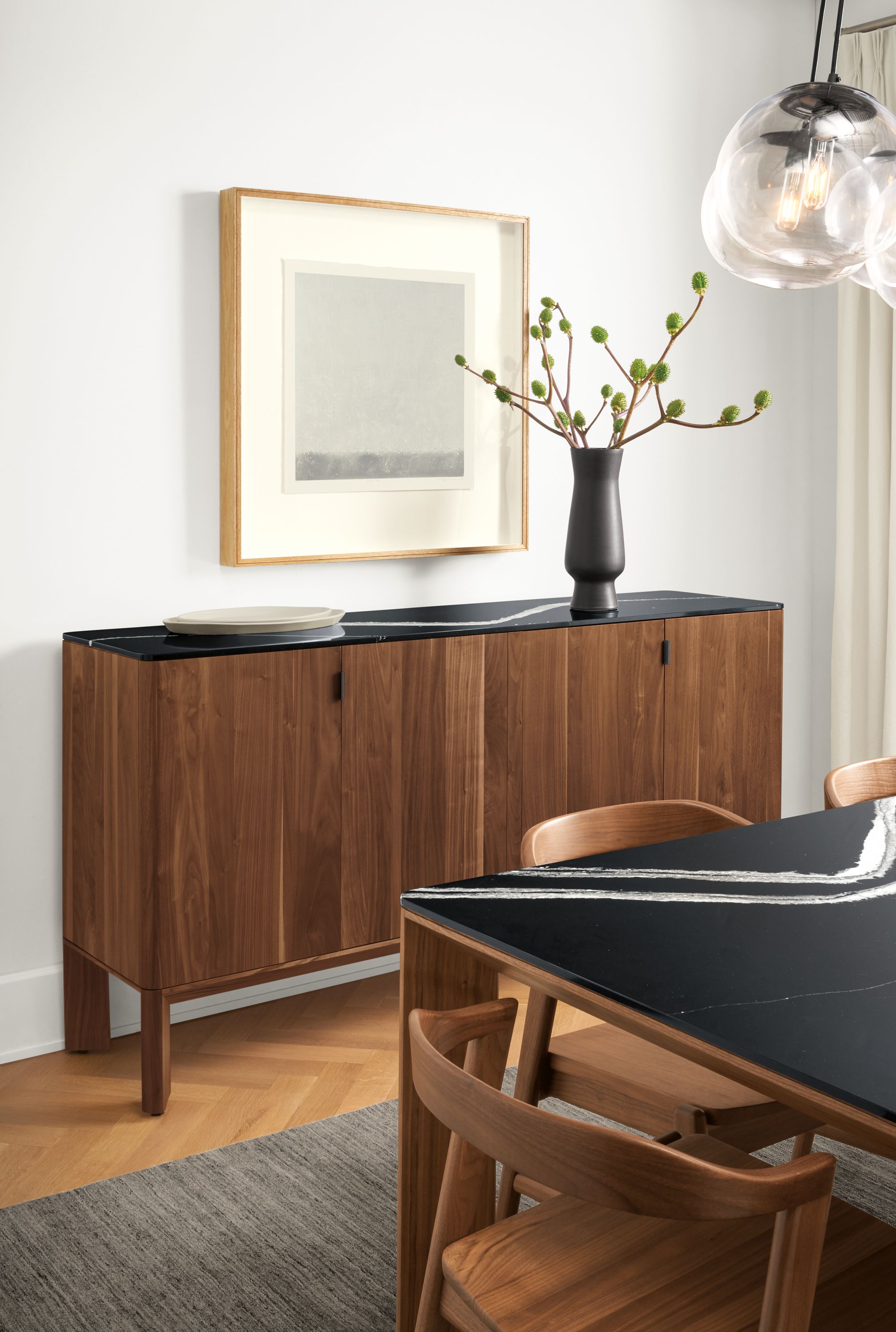 Detail of Pren storage cabinet in walnut with Cambria Mersey top in dining room.