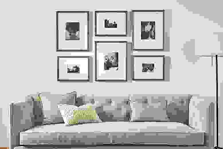 detail of profile picture frame set hung above sofa