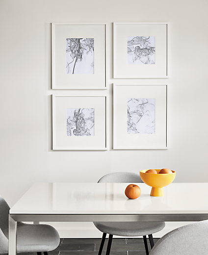 detail of four profile frames in white in dining room
