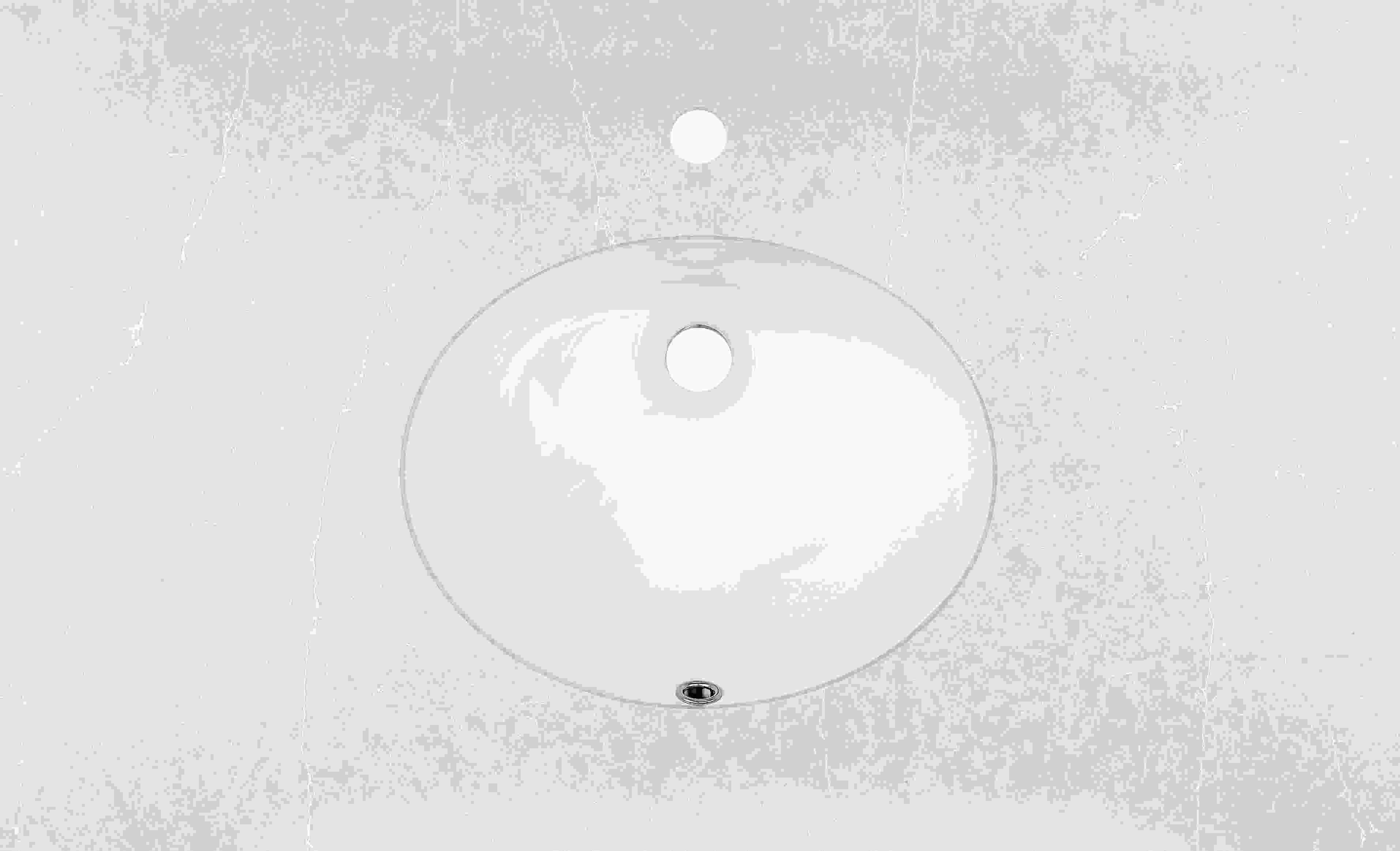 Top down detail of Vanity top in light grey quartz with oval sink and one facet holes.