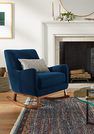 living room with fireplace featuring quinn rocking chair in blue velvet.