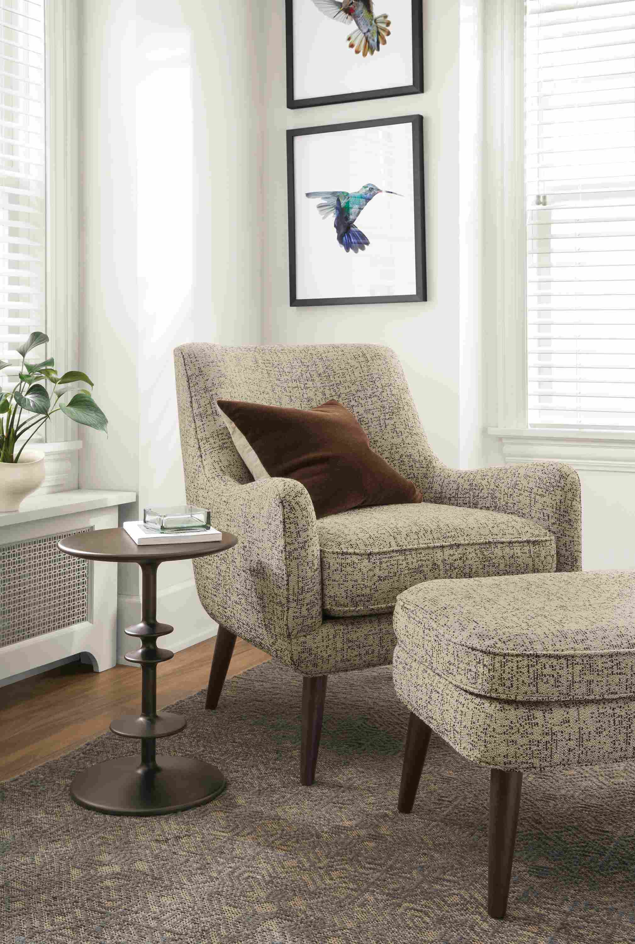 Detail of Quinn chair in Sym Putty fabric with Quinn ottoman.