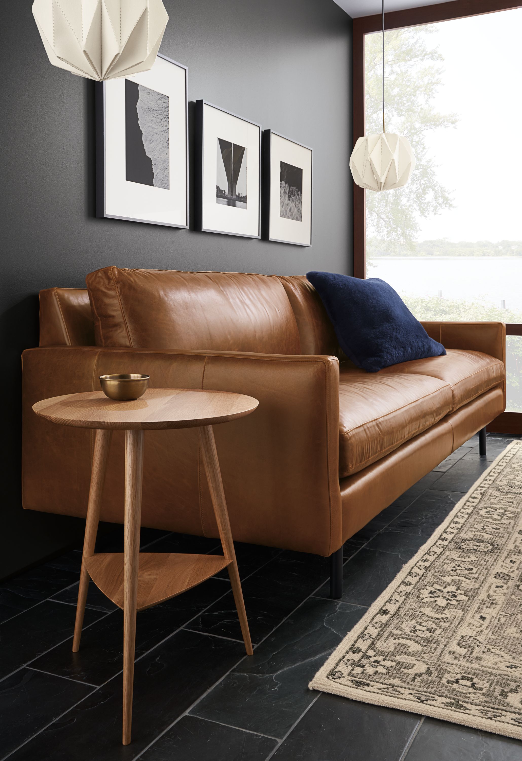 Living room with Rae 18-diameter round end table in White oak with Jasper leather sofa.