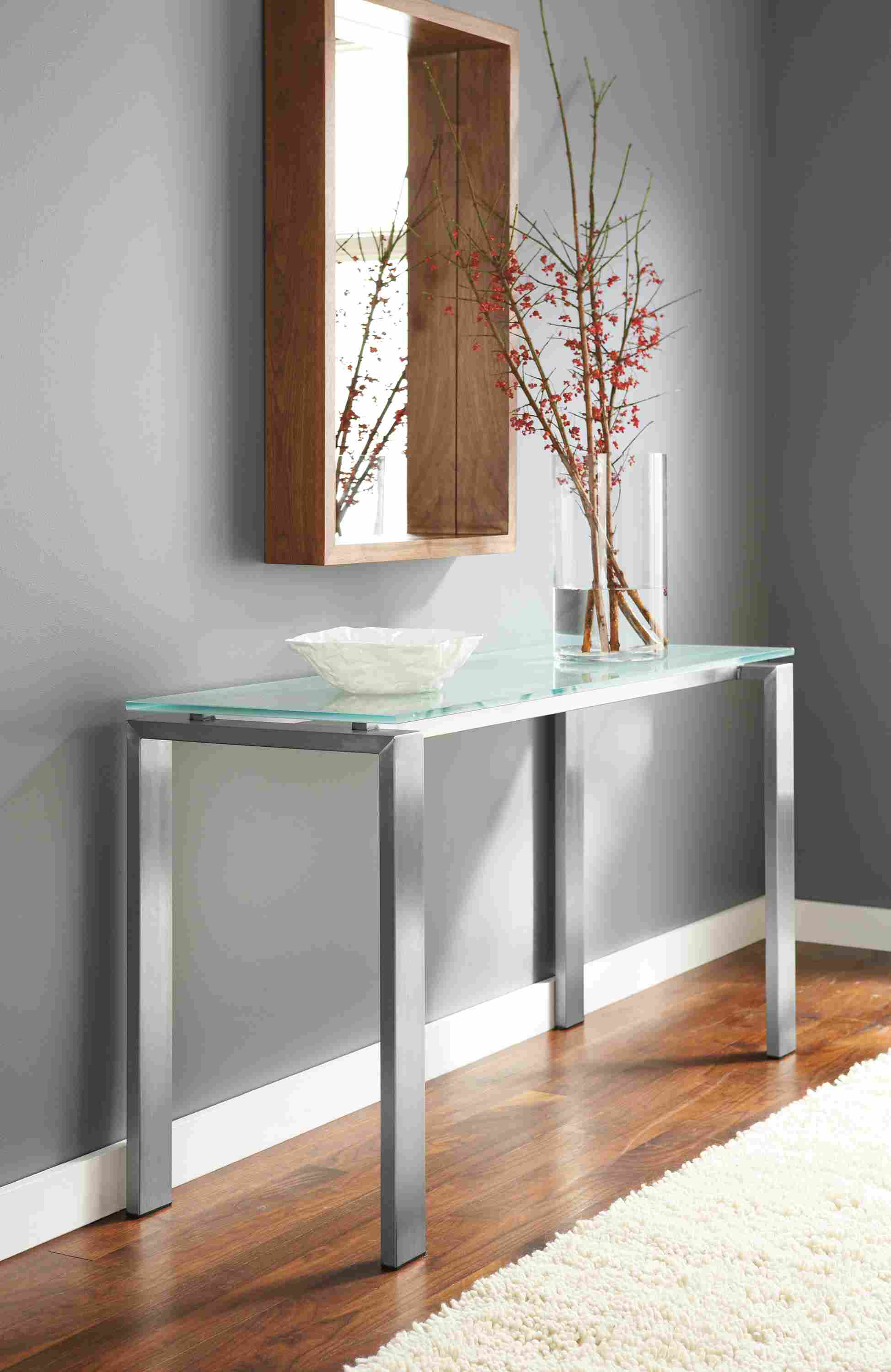 Detail image of Rand 54-by-18 high console table in stainless steel and clear glass top.
