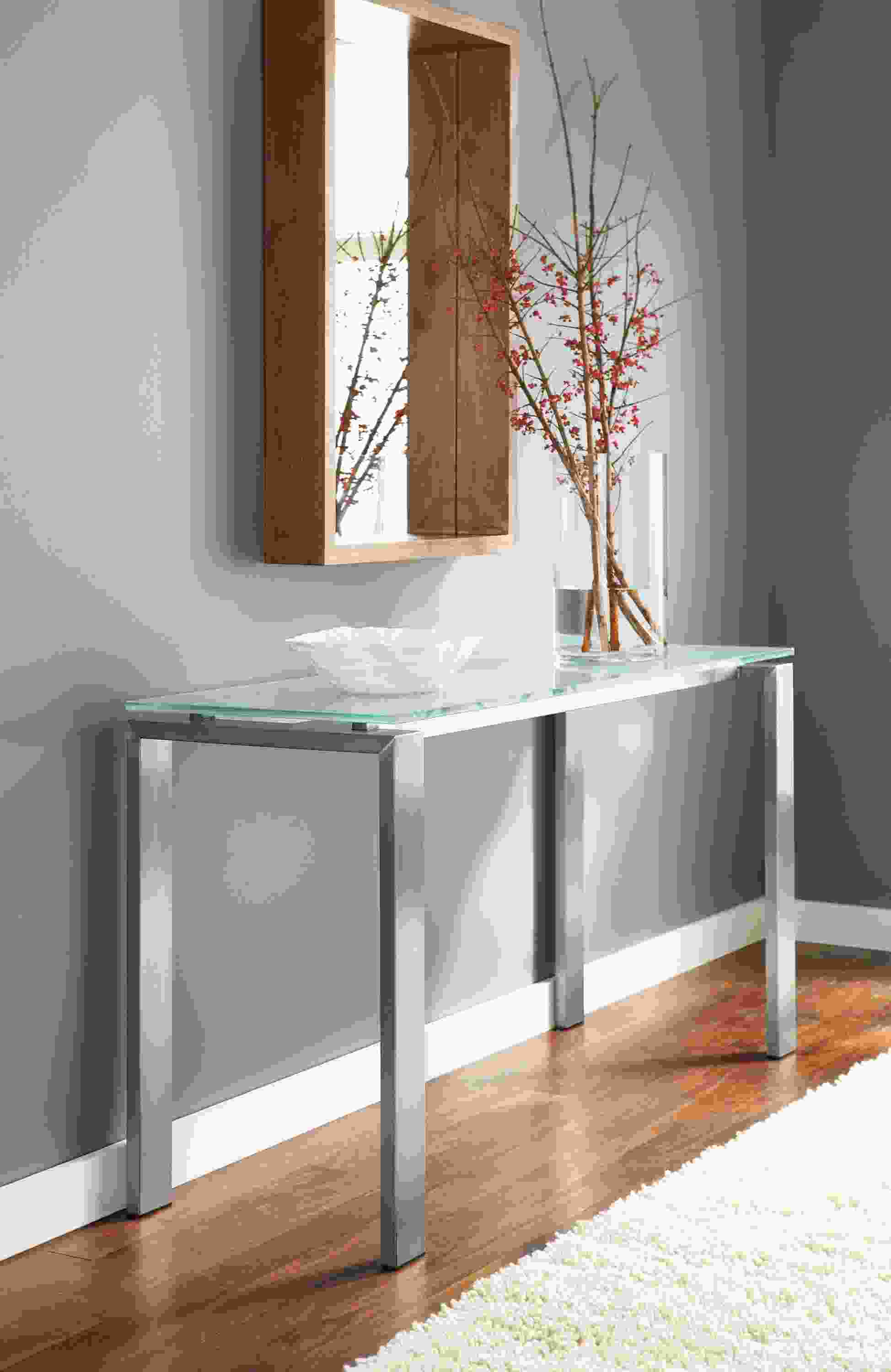Detail image of Rand 54-by-18 high console table in stainless steel and clear glass top.