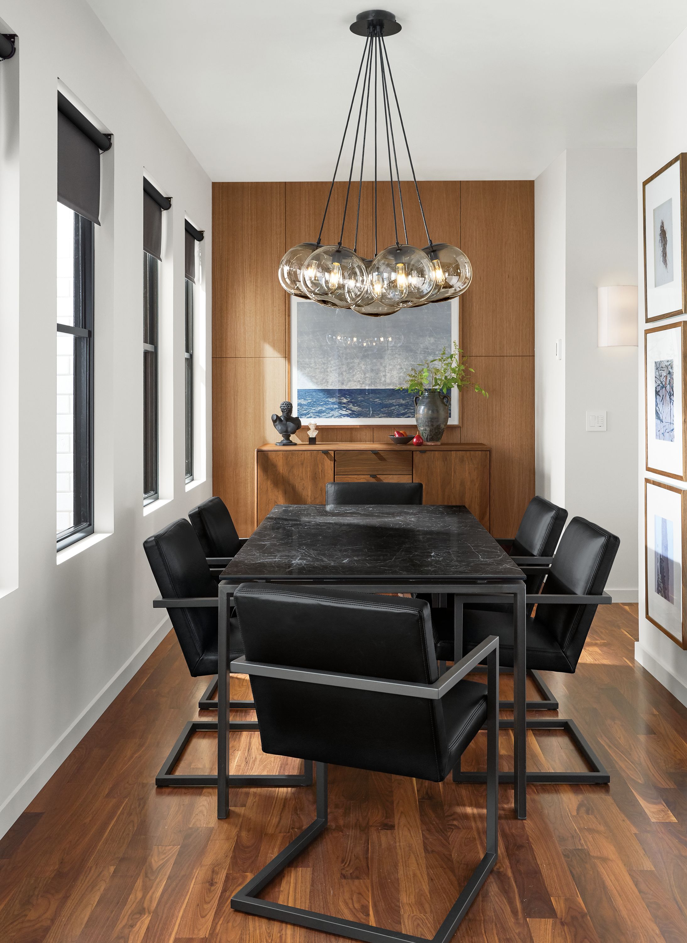 Detail of Rand dining table in dining room with natural steel base and black marbled top.