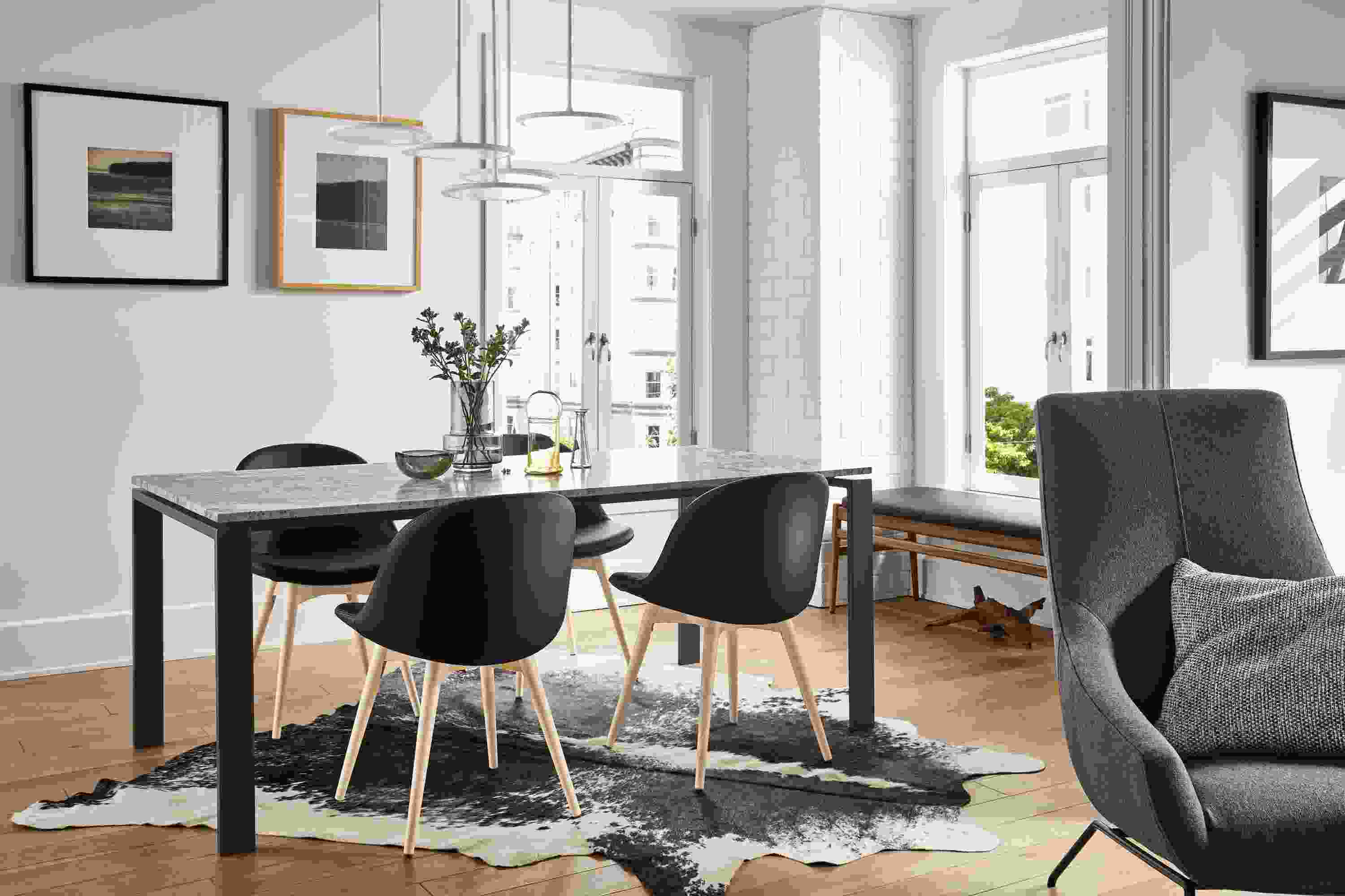 Great room with Rand dining table with natural steel base and Wiscont White top.