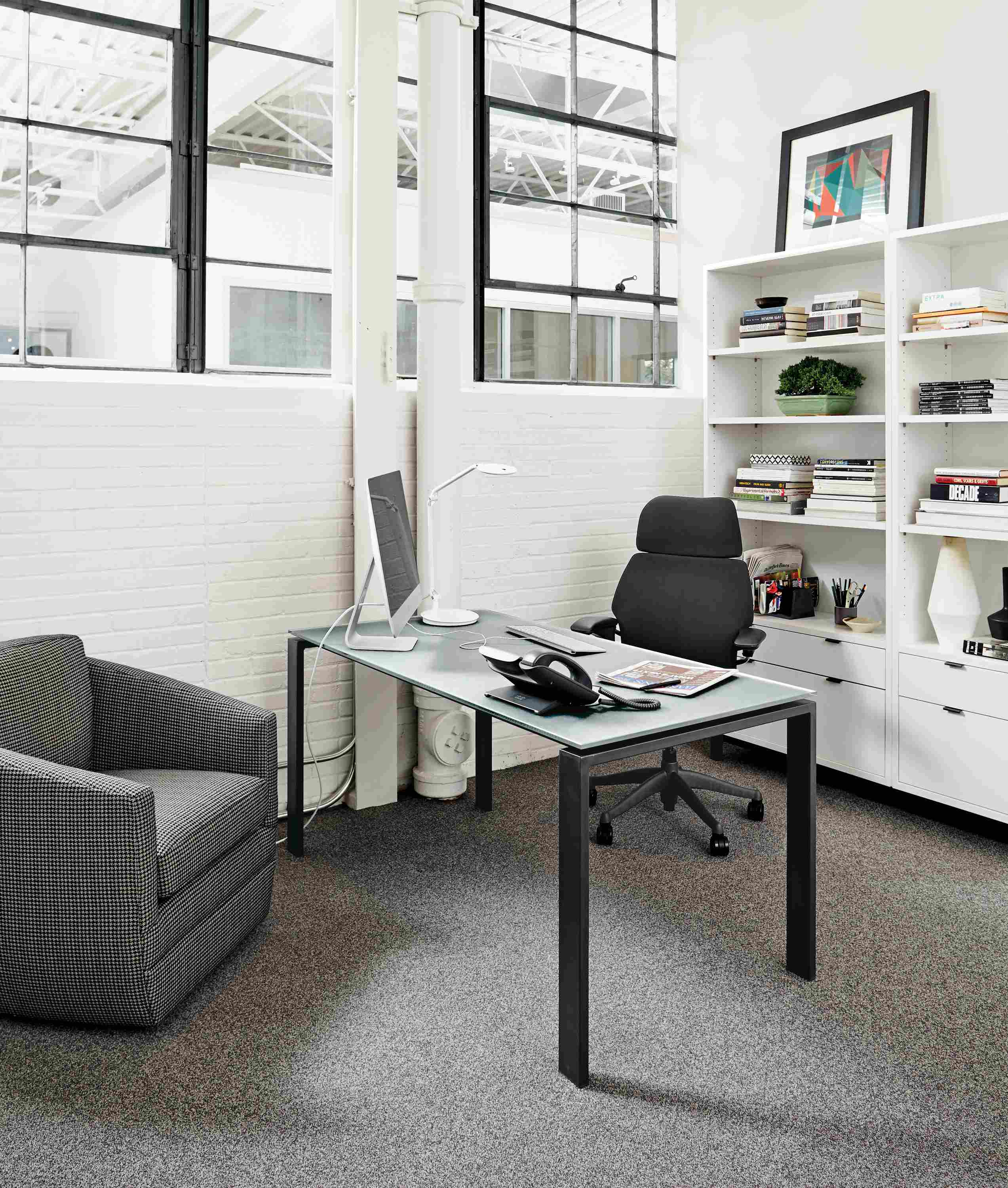 Office with Rand desk with natural steel base and etched glass top.