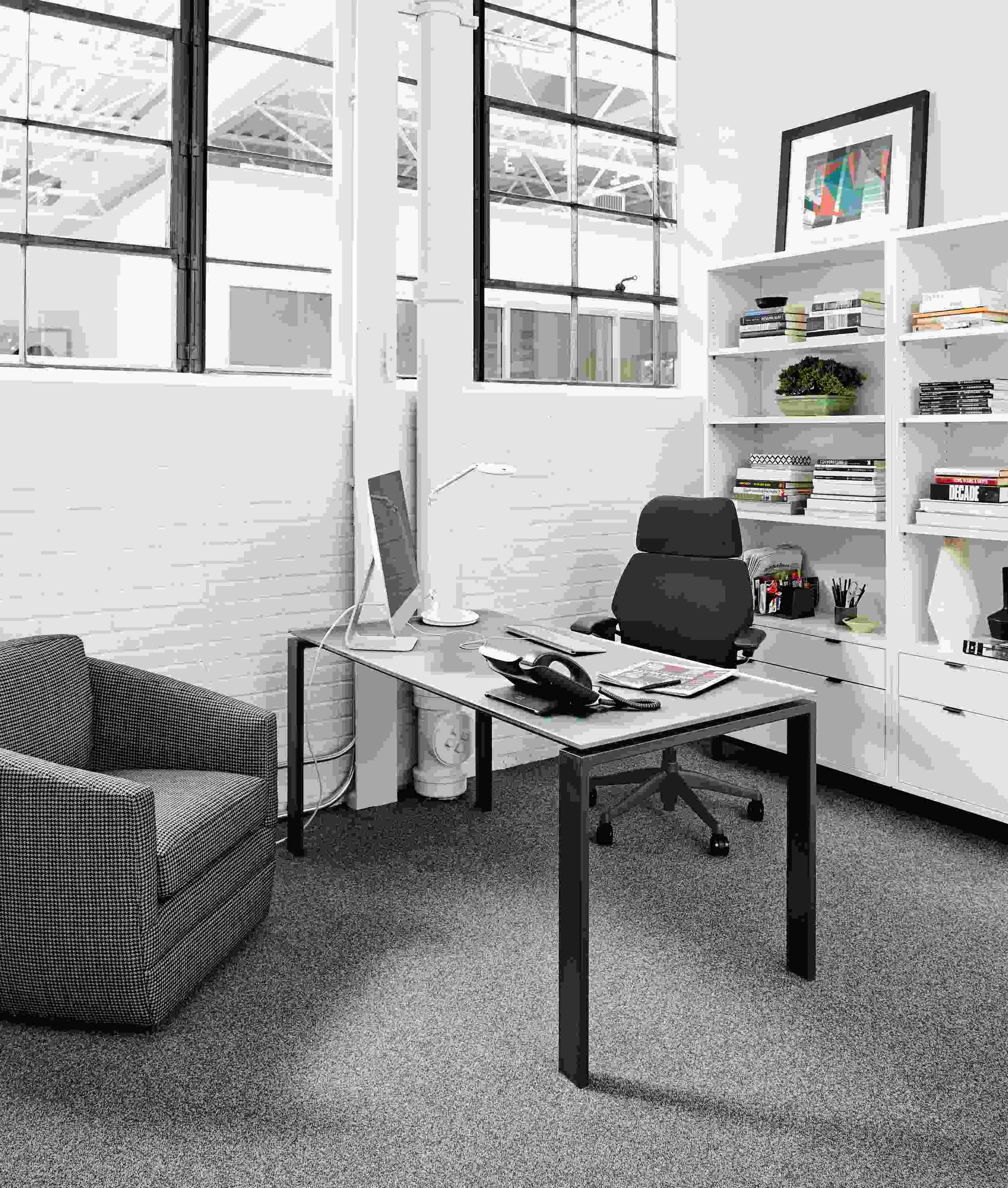 Office with Rand desk with natural steel base and etched glass top.