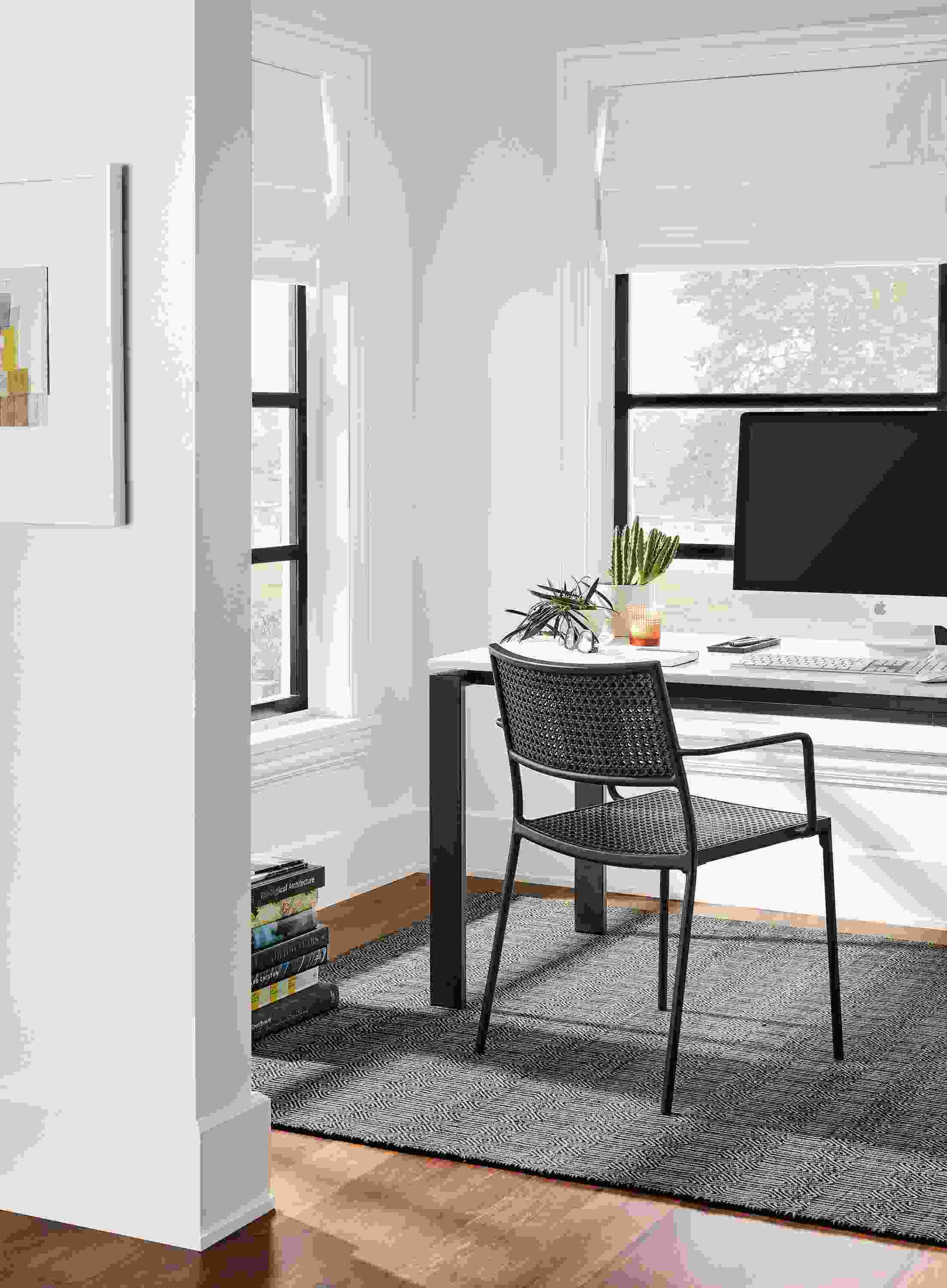 Office area with Rand 60-wide table in natural steel with marbled white quartz top and Plat chair in black.