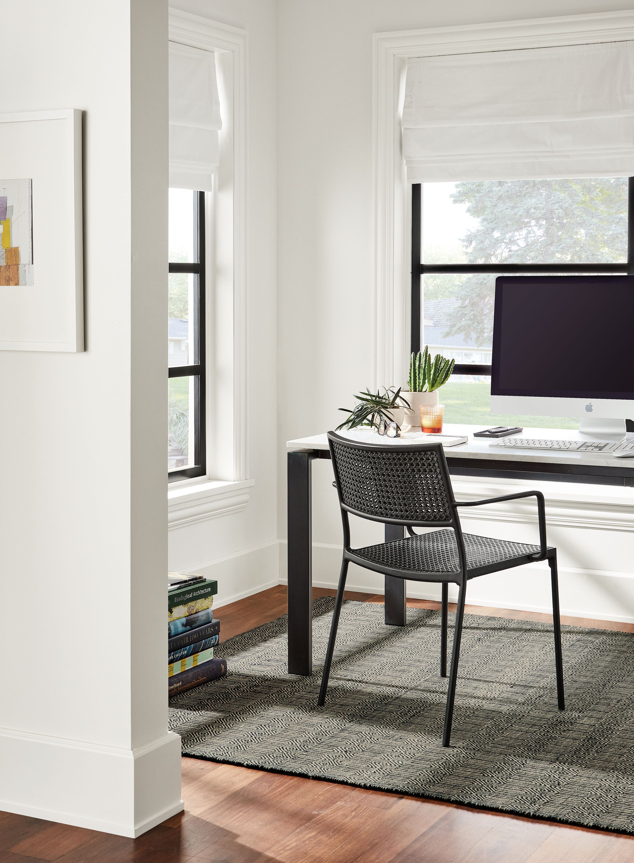 Office area with Rand 60-wide table in natural steel with marbled white quartz top and Plat chair in black.