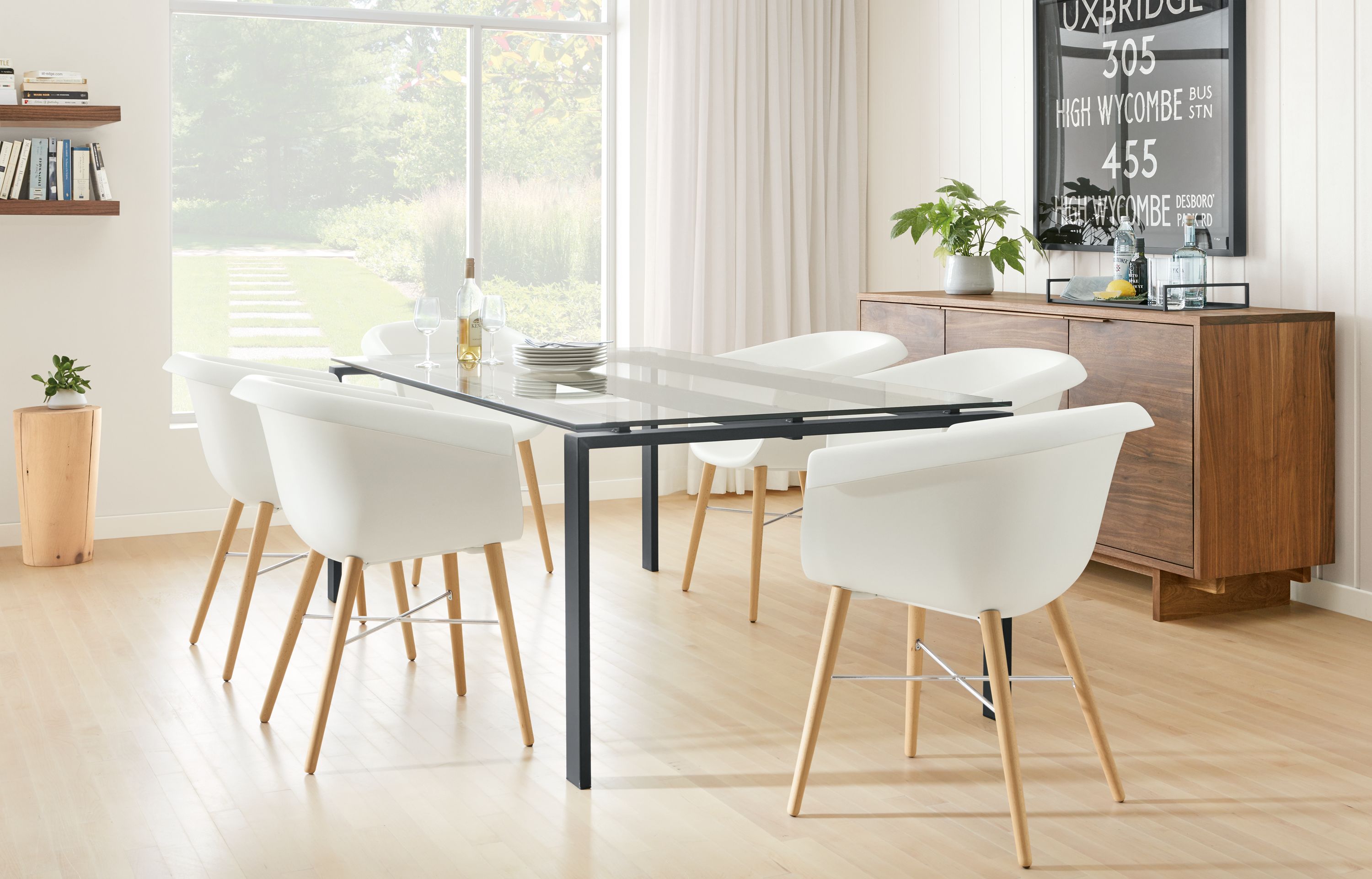 Detail of Rand dining table with natural steel base and clear glass top.