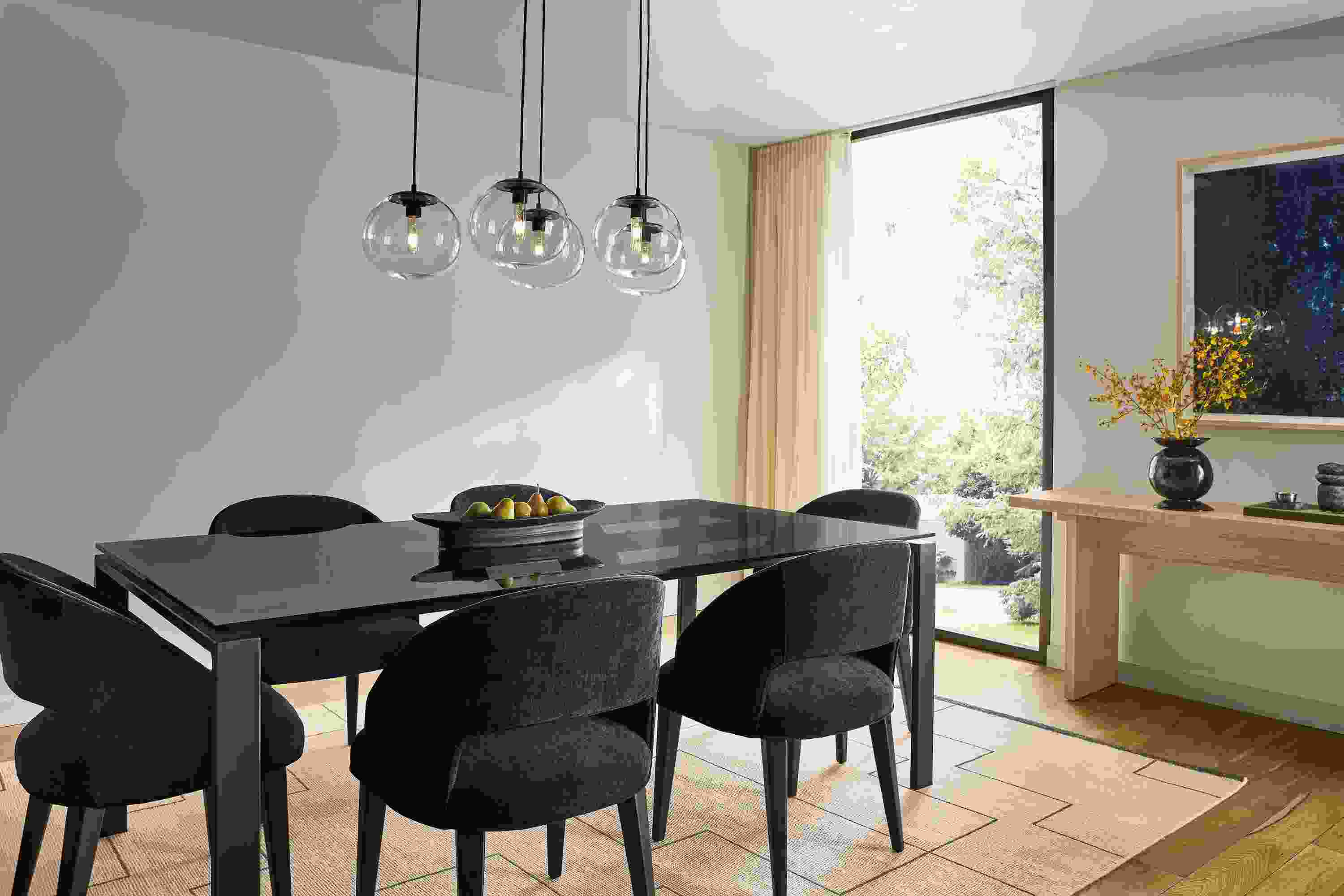 Dining Room with Rand 78-wide table in smoked glass, 6 Esme chairs in Mori Navy and Navi 8 by 10 rug in Ivory/Black.